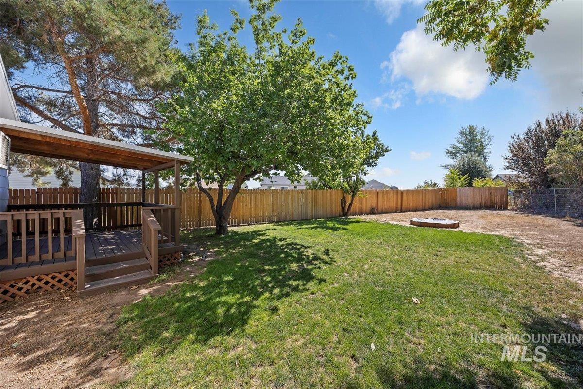 Fenced backyard with a wooden deck