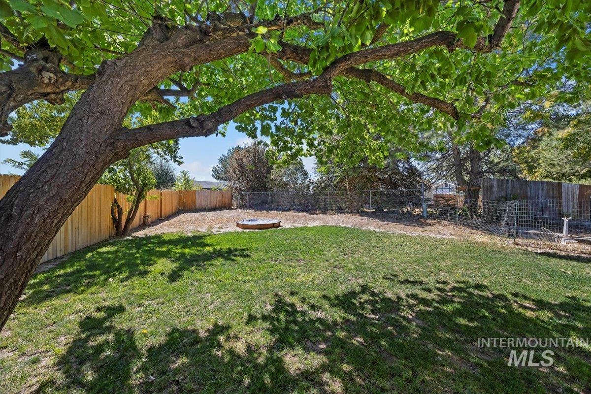 Fenced backyard featuring an outdoor fire pit