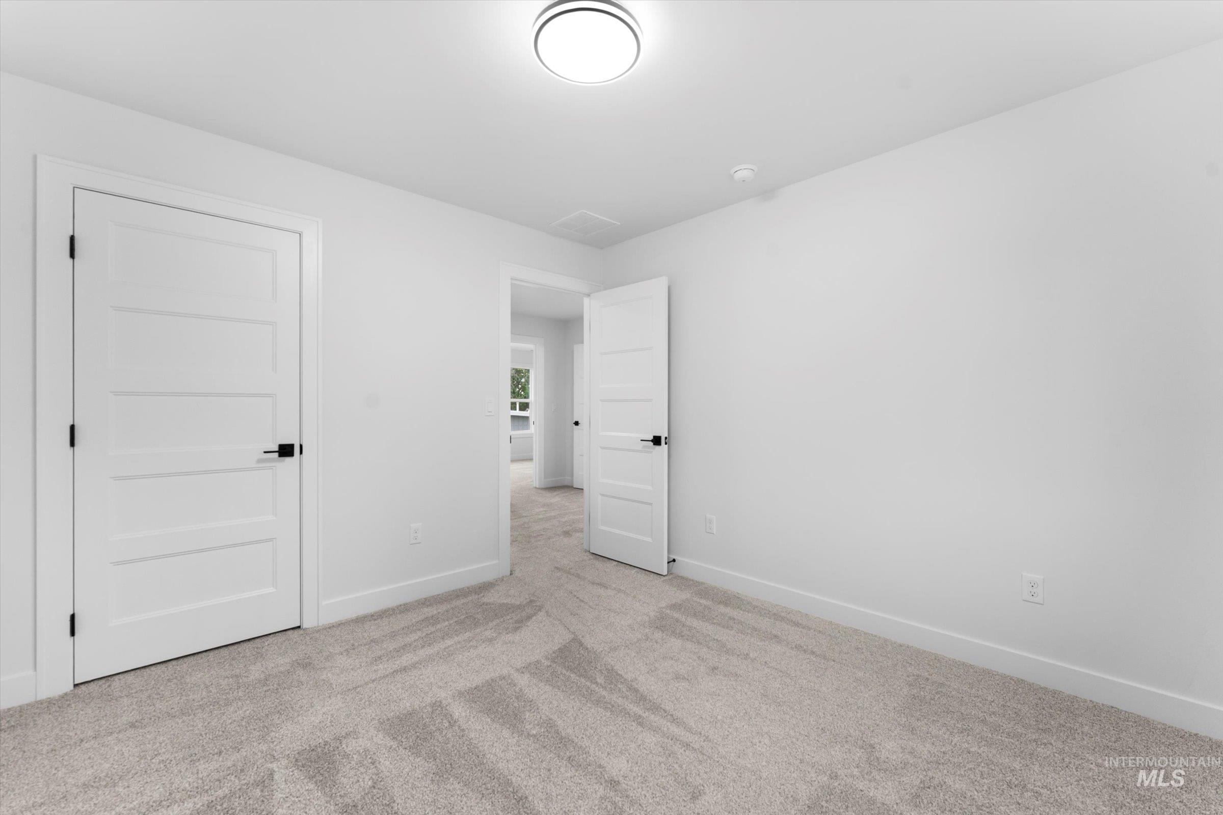 Unfurnished bedroom featuring carpet and baseboards