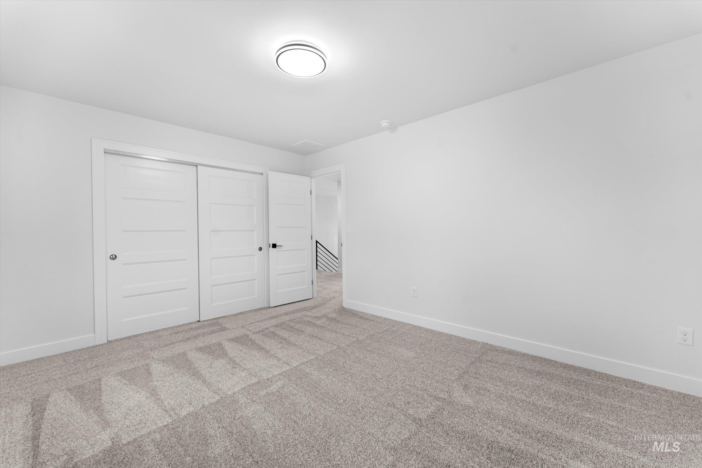 Unfurnished bedroom with carpet flooring and a closet