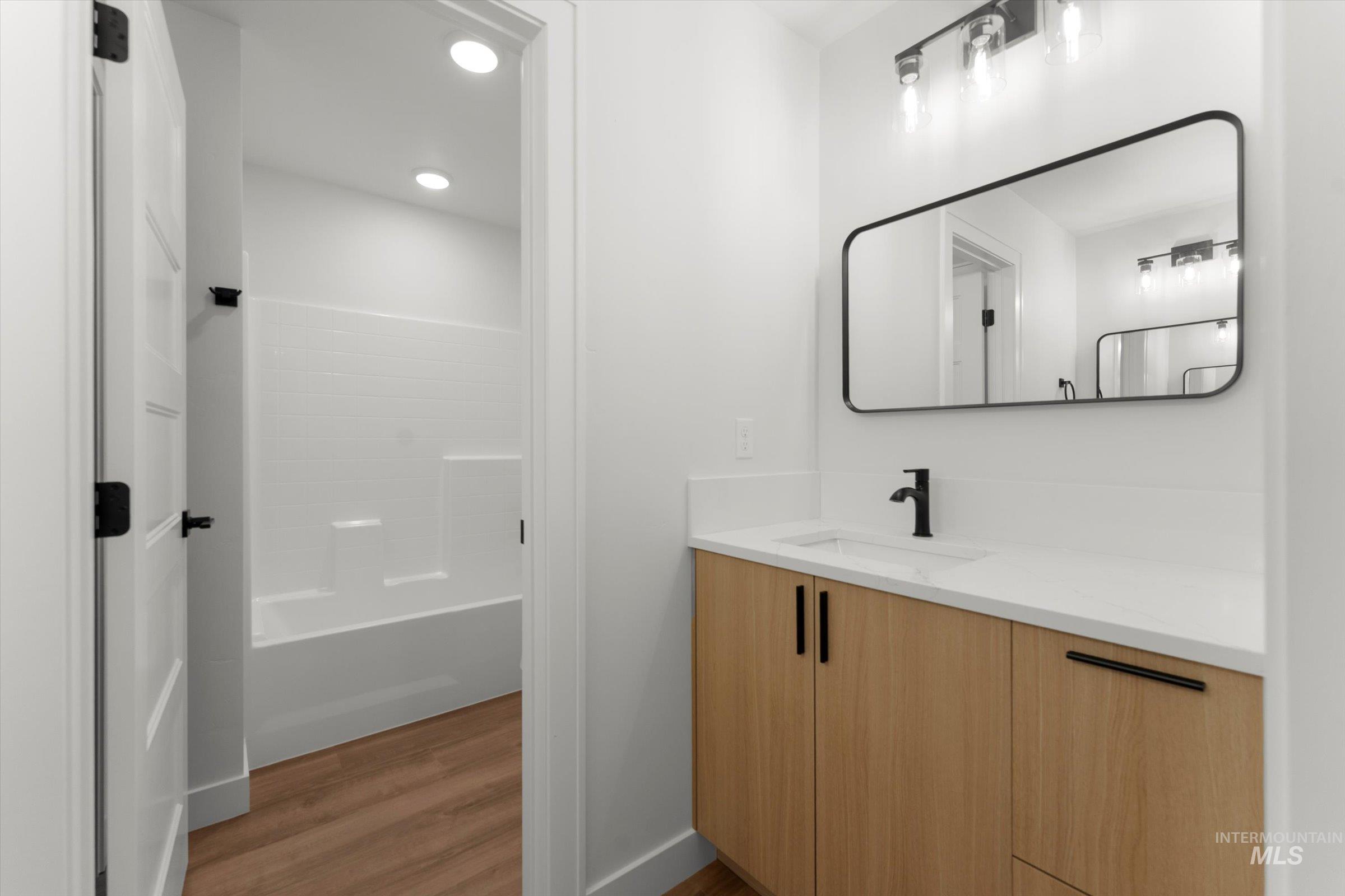 Bathroom featuring vanity, light wood-style floors, and recessed lighting