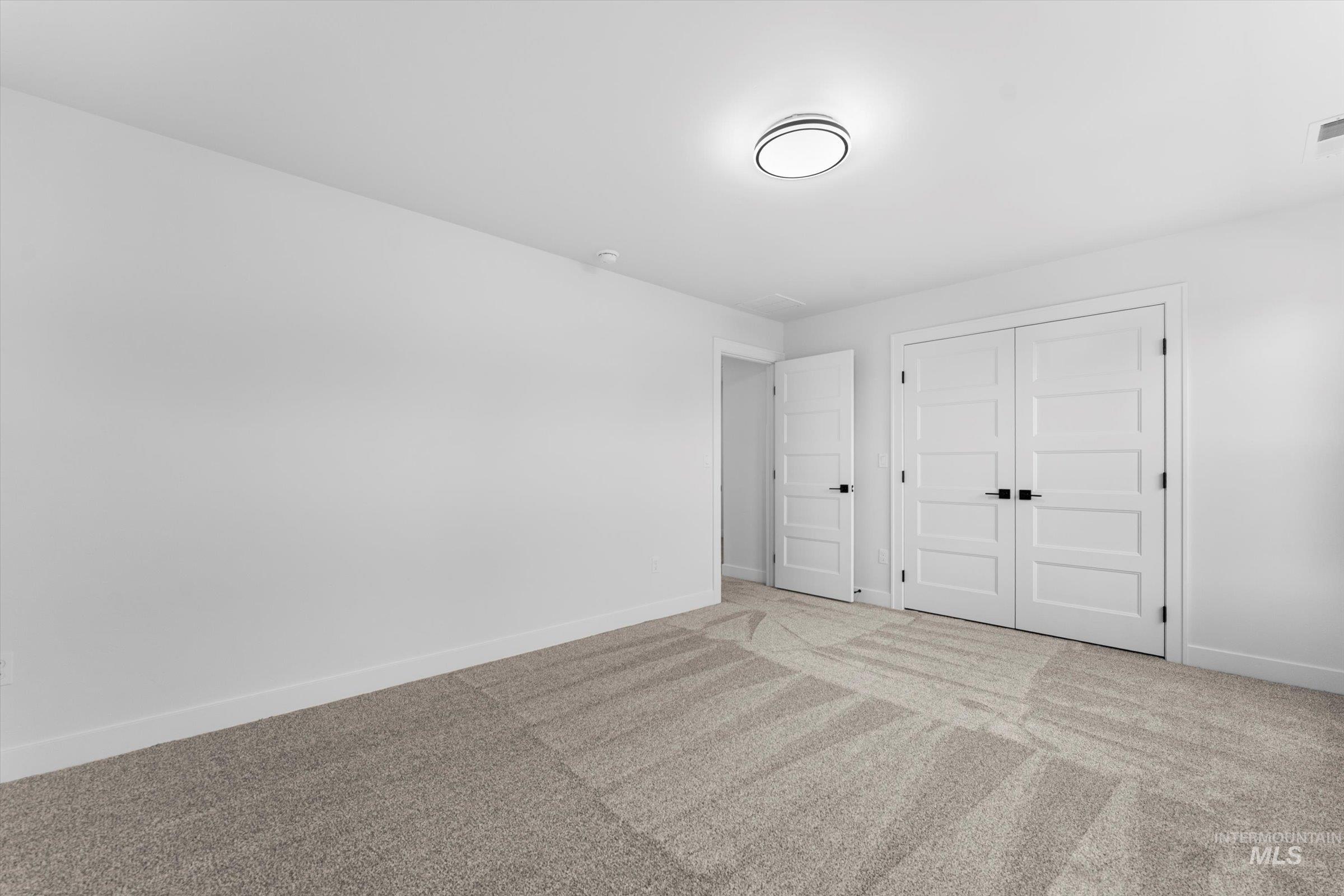 Unfurnished bedroom with carpet flooring and a closet