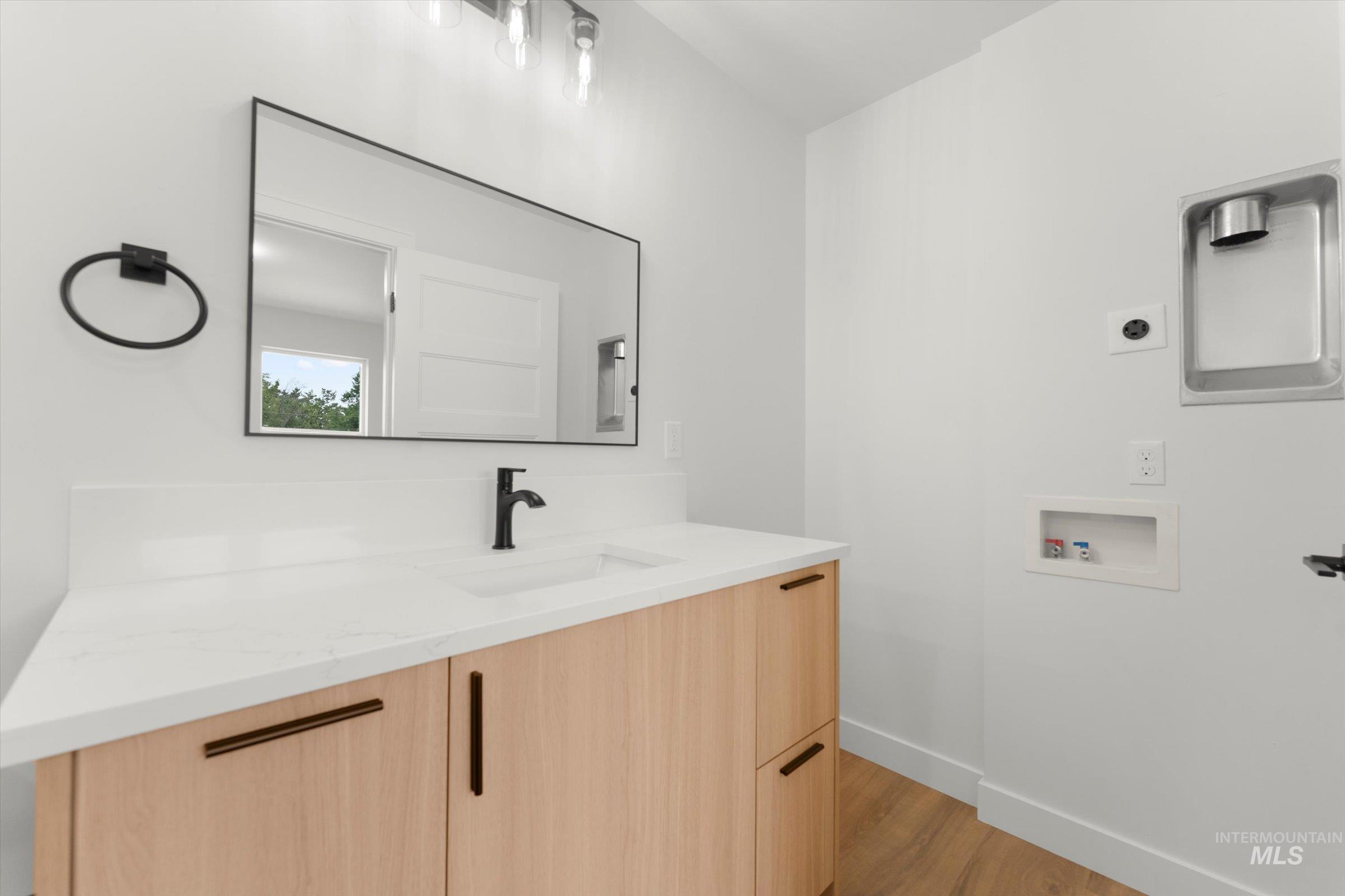 Bathroom with vanity and light wood-type flooring