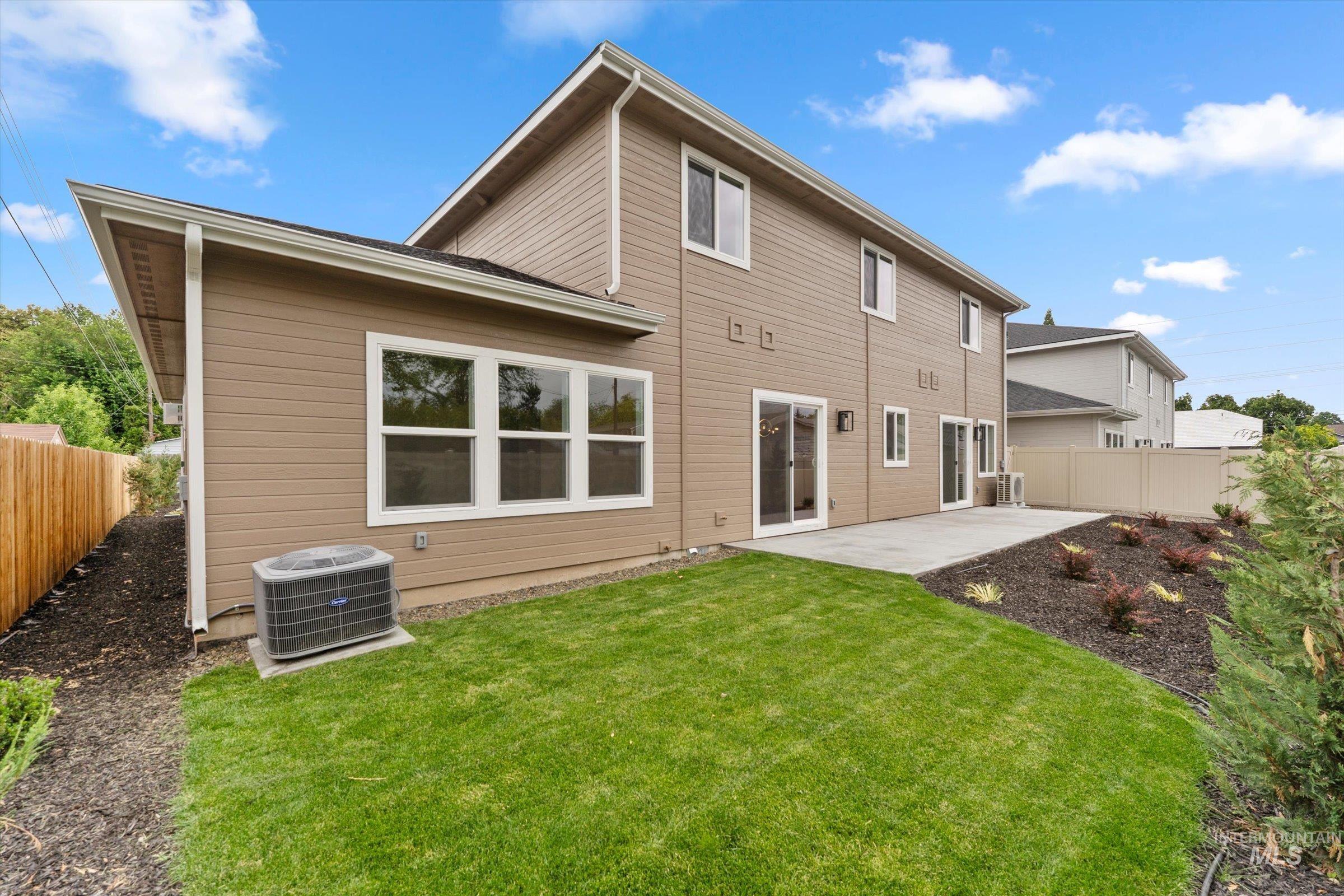 Rear view of house with a patio and a fenced backyard