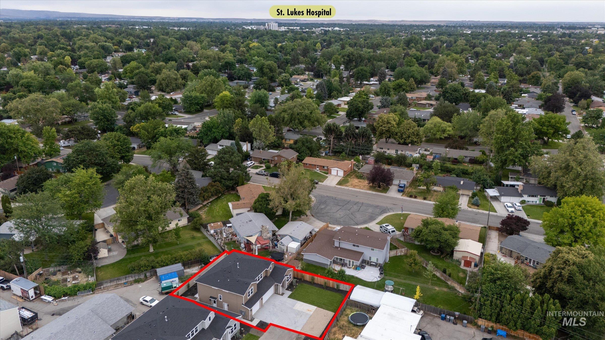 Aerial perspective of suburban area featuring property boundaries highlighted