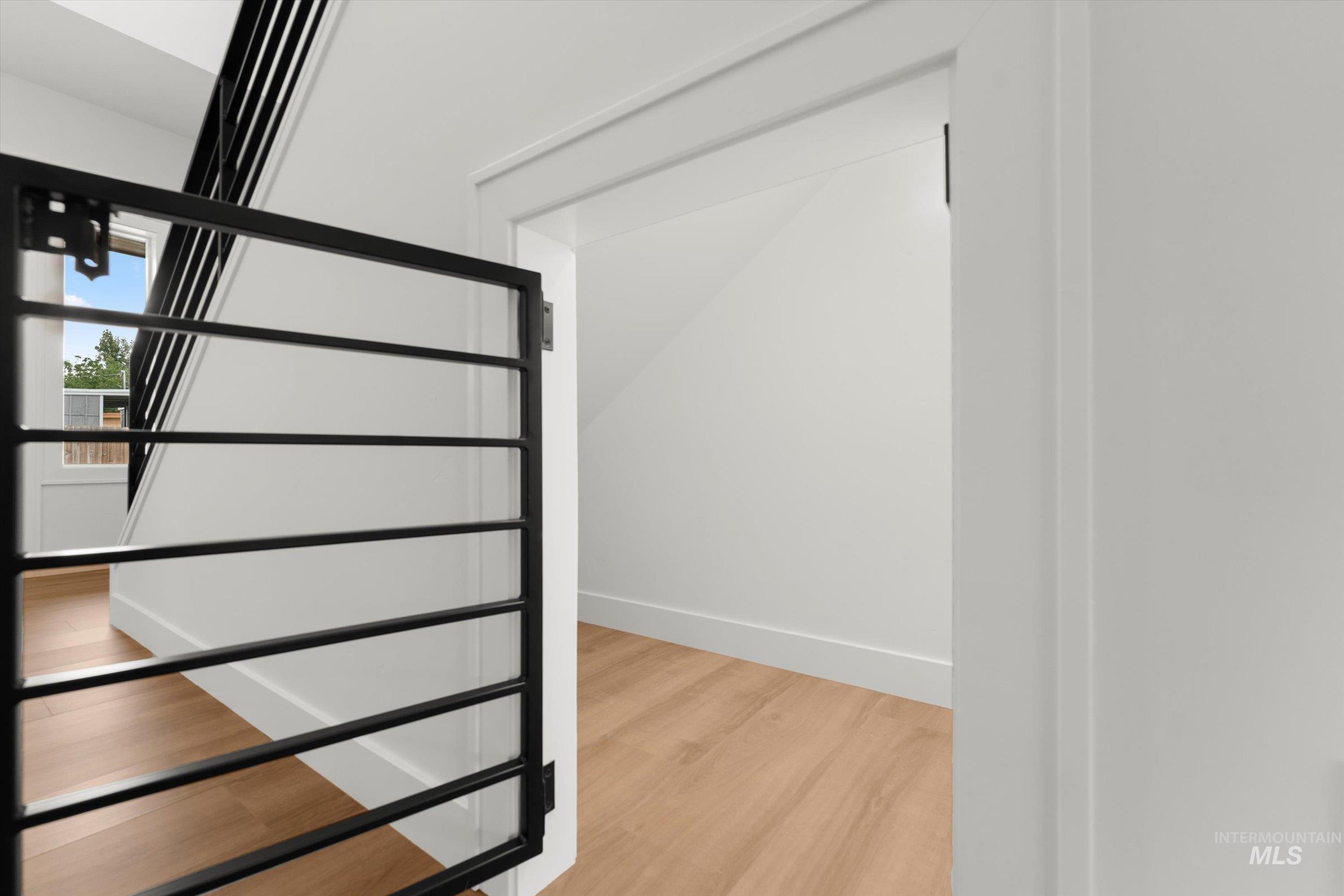 Stairway featuring wood finished floors and baseboards