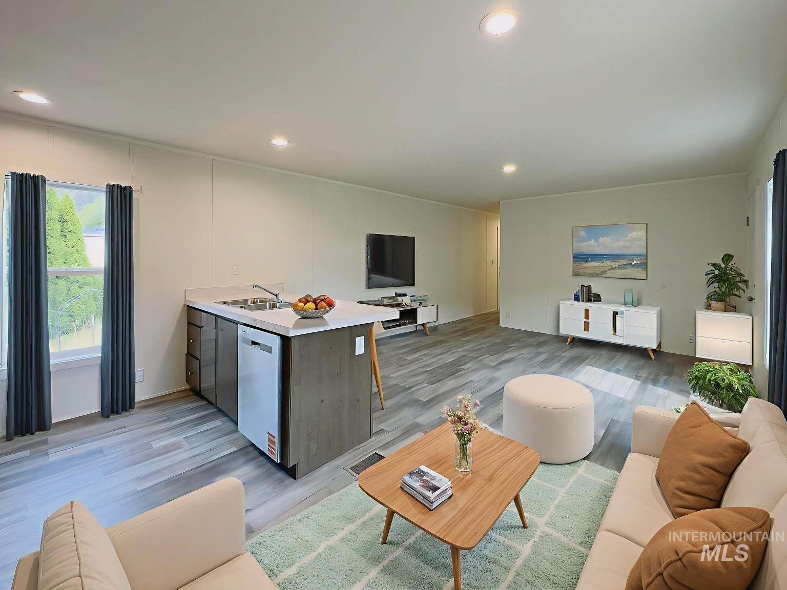 Living area with recessed lighting and light wood-type flooring