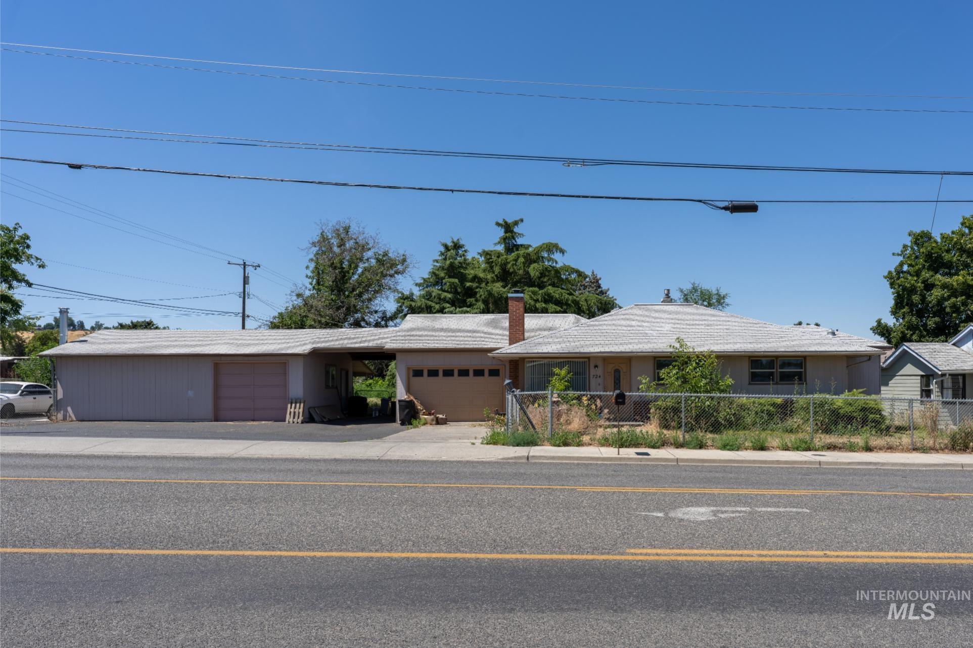 Ranch-style home with an attached garage and a chimney