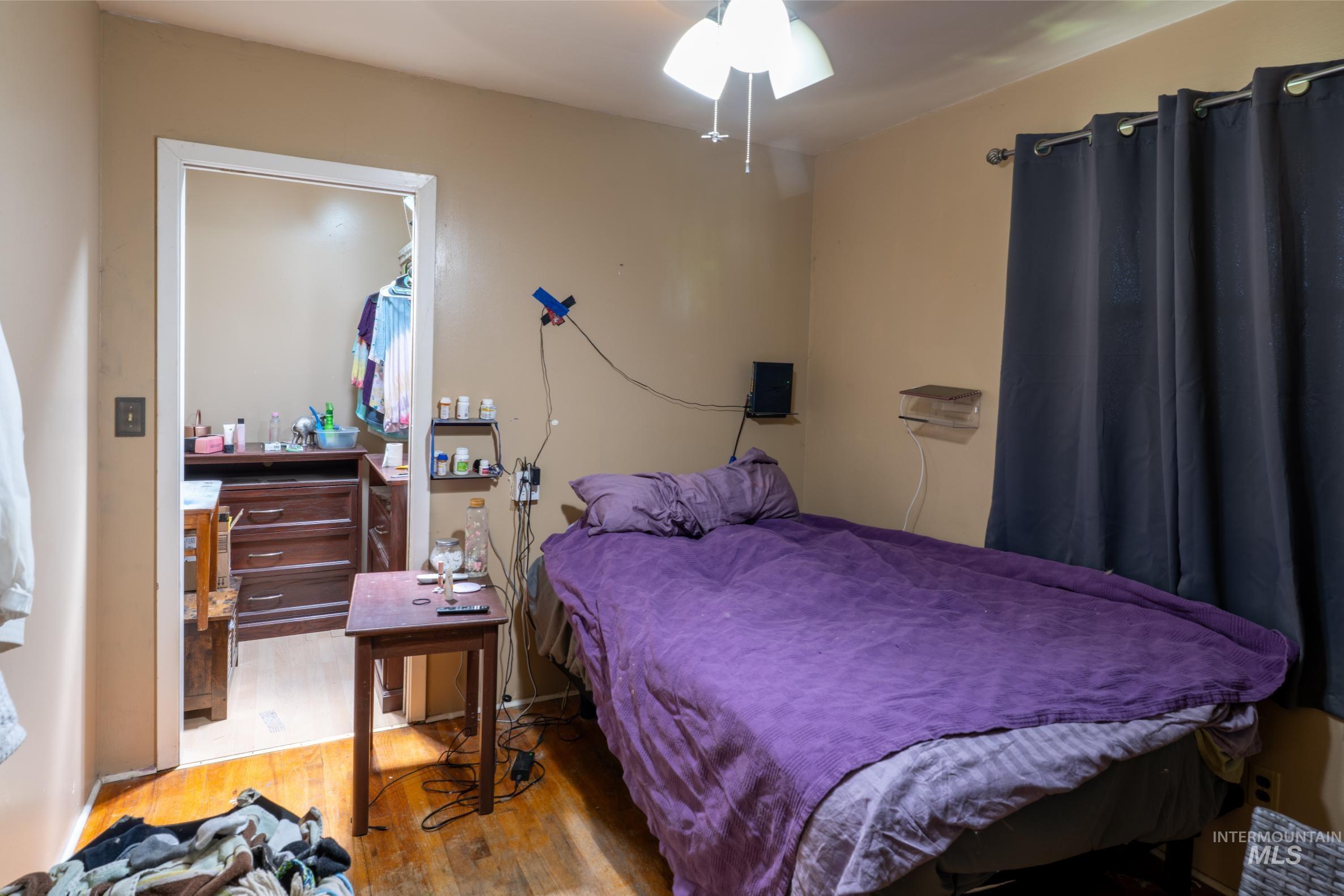 Bedroom featuring wood finished floors and a ceiling fan