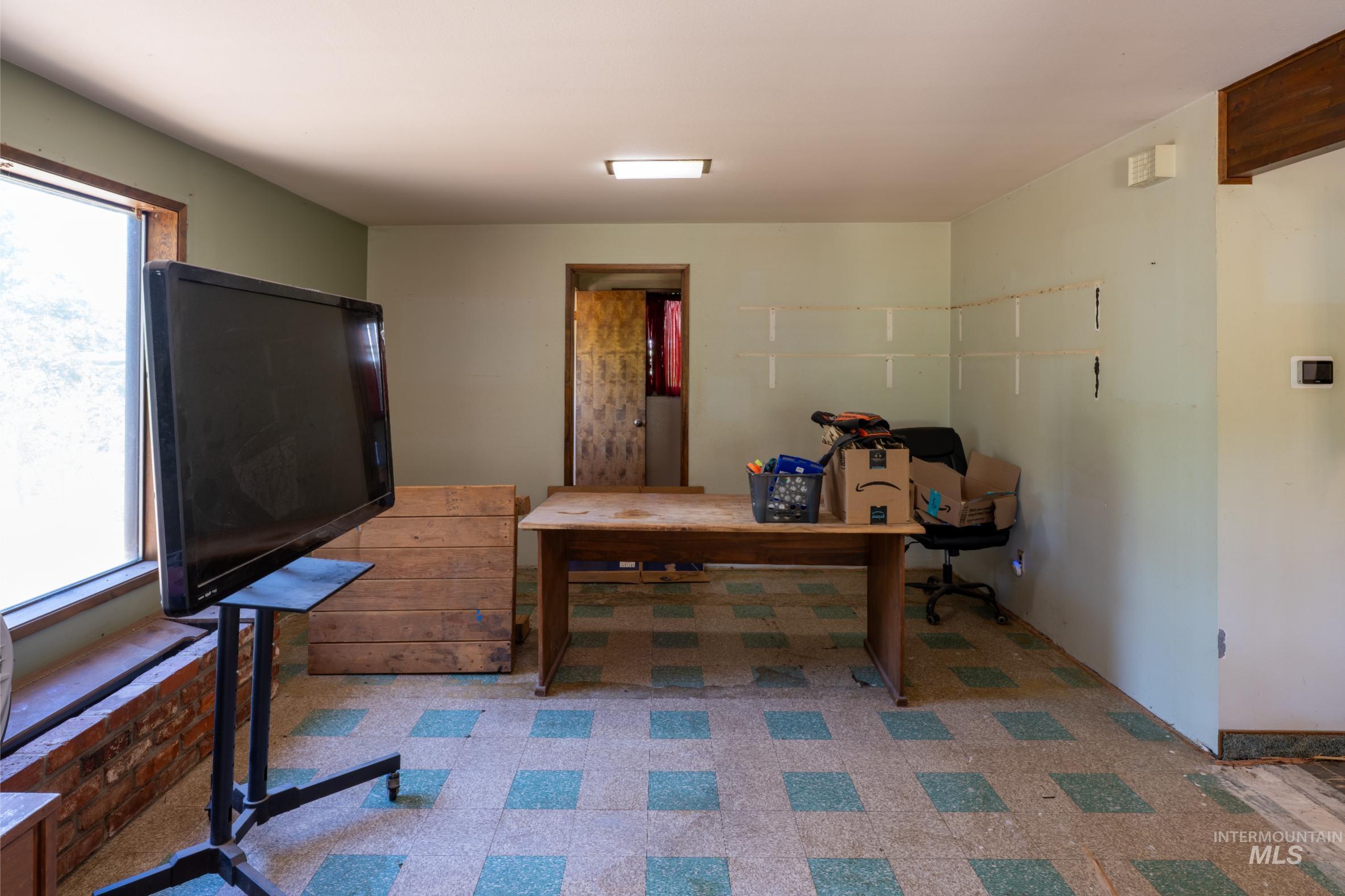 Office area featuring light floors