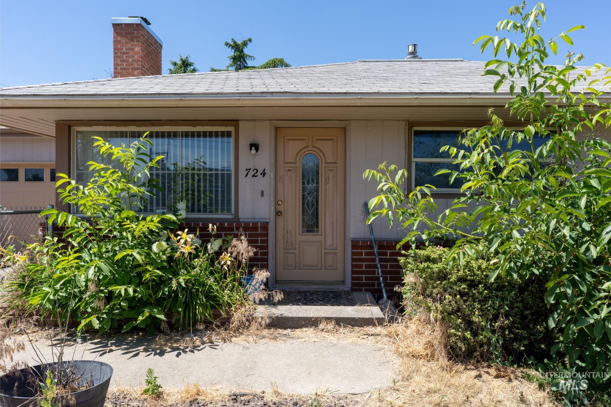 Entrance to property featuring brick siding and a chimney