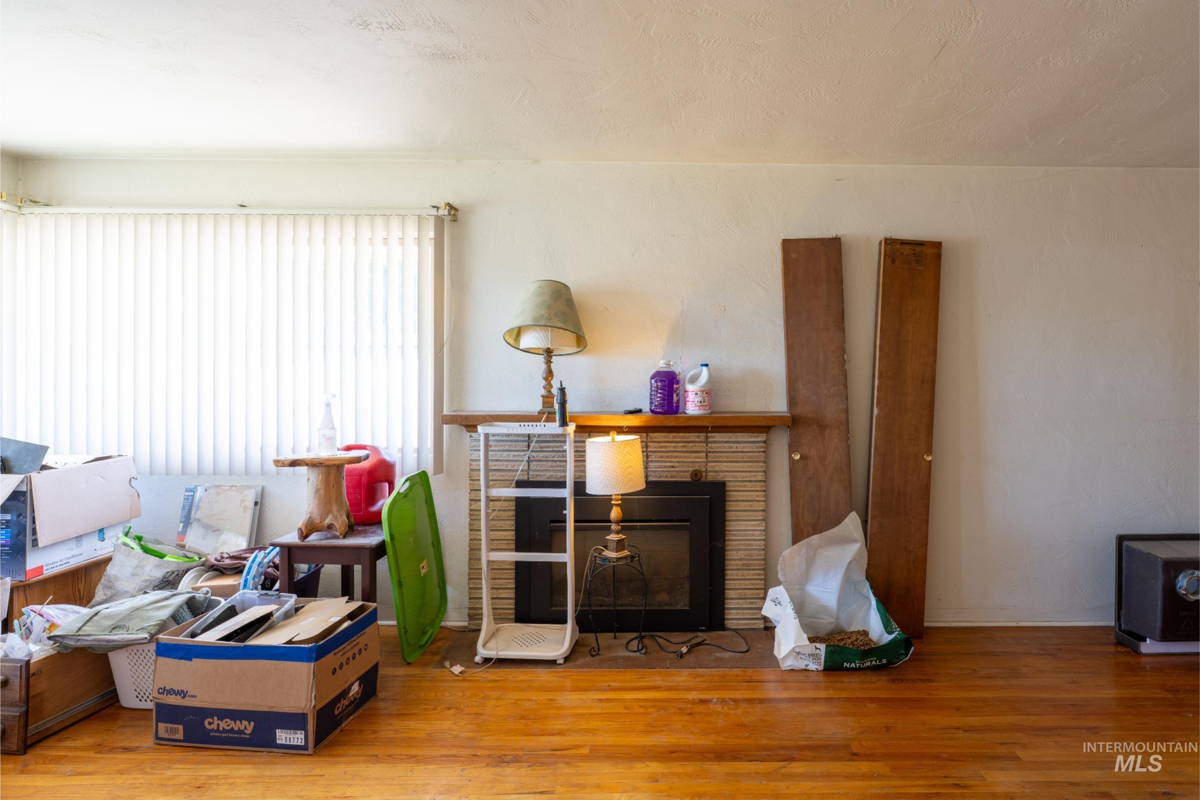 Living room with wood finished floors and a textured ceiling