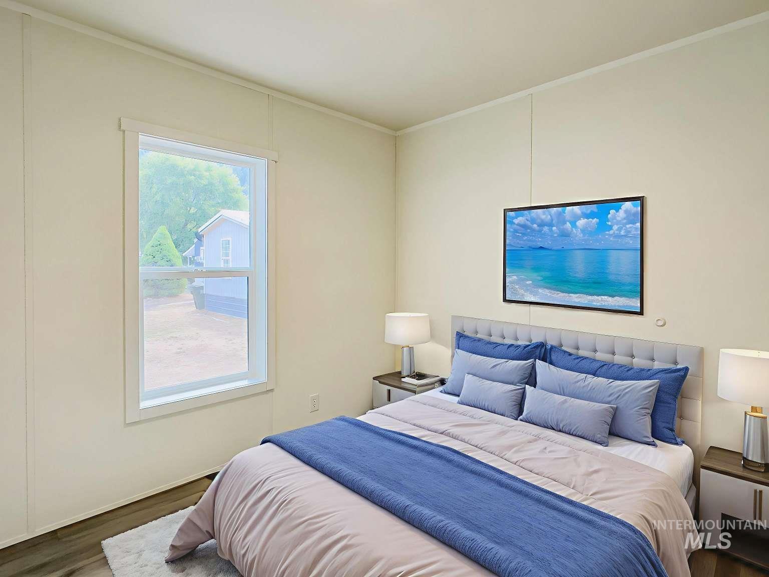 Bedroom featuring wood finished floors and ornamental molding