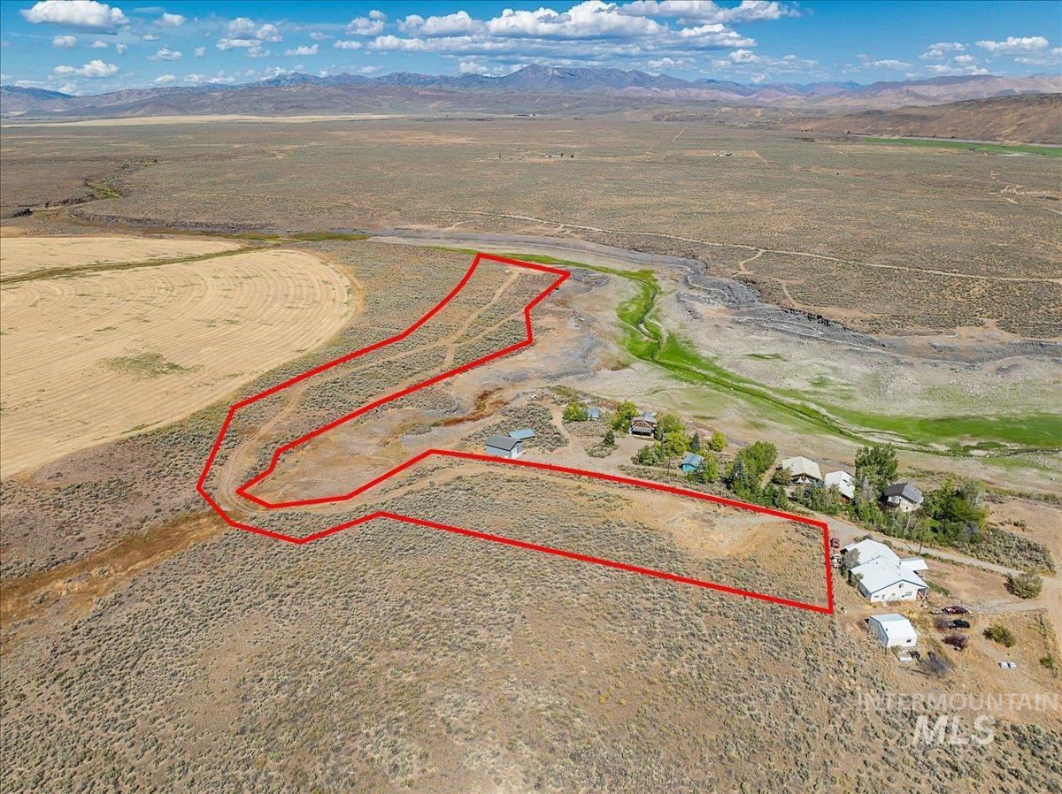Overview of rural landscape featuring property boundaries highlighted and mountains