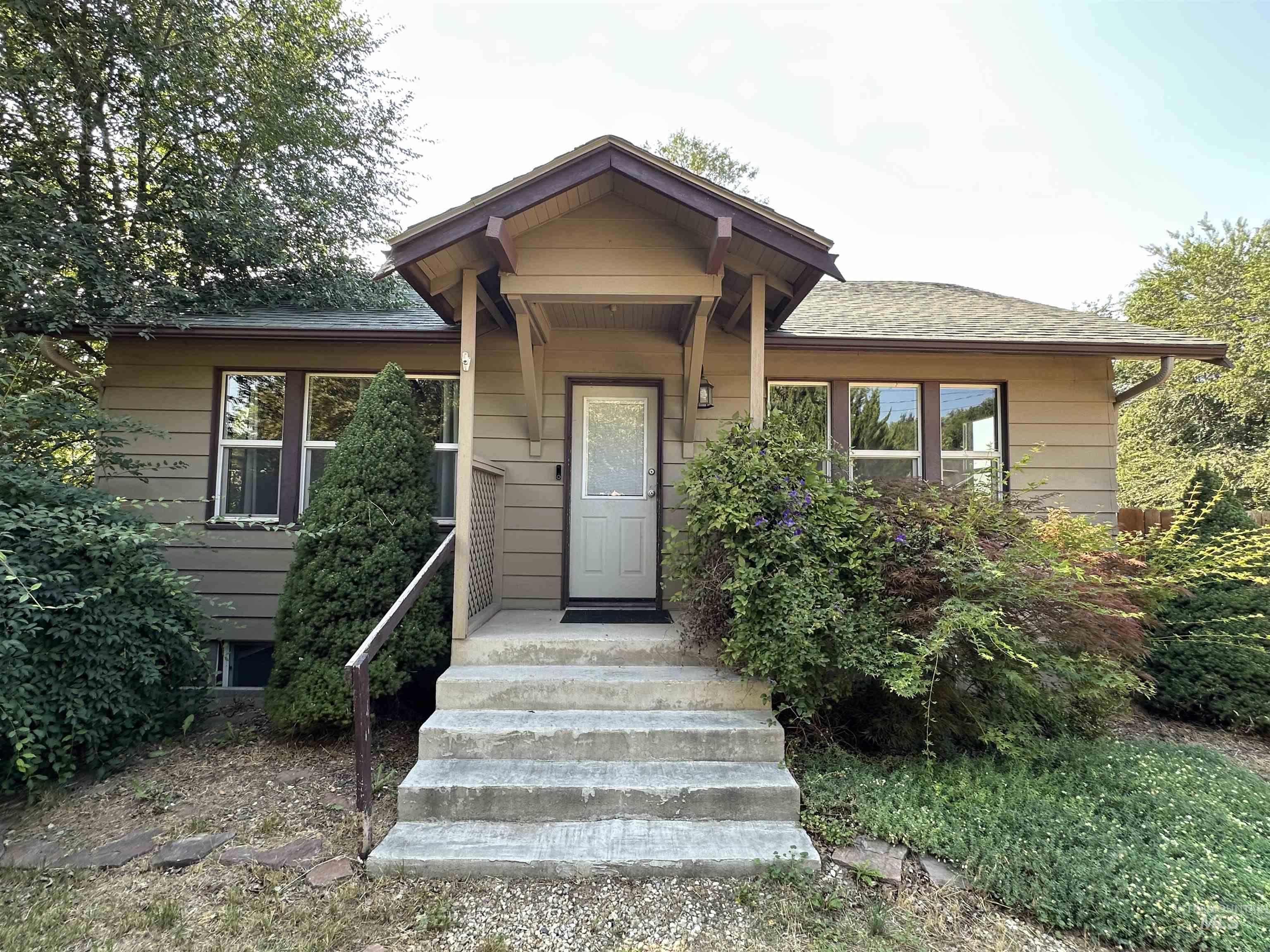 View of front of home with roof with shingles