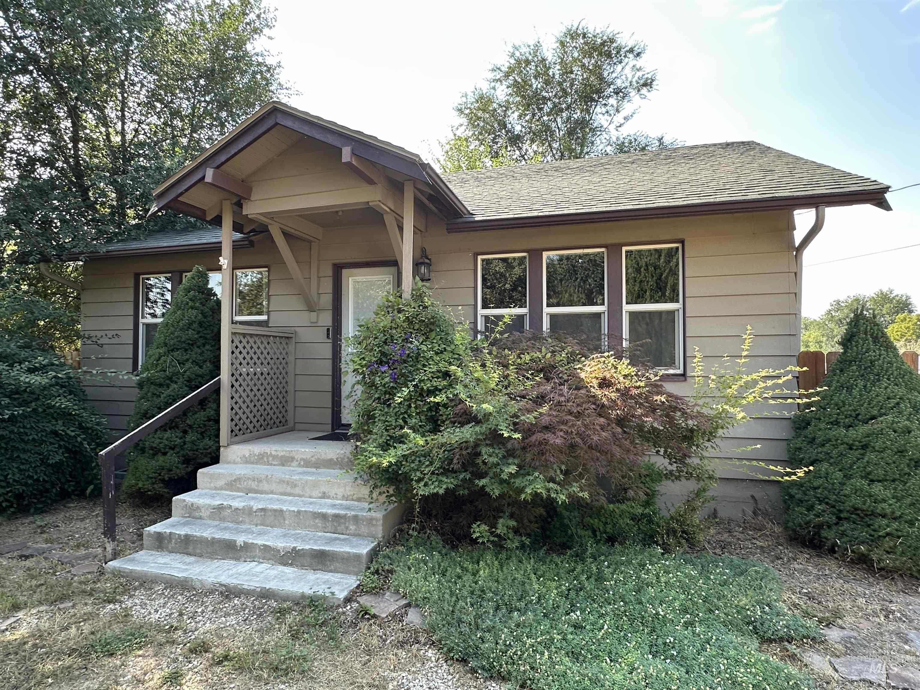 View of front of property with roof with shingles