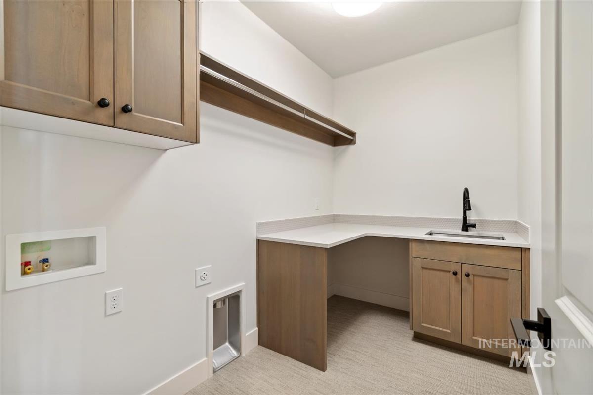 Laundry area featuring cabinet space, light carpet, washer hookup, and hookup for an electric dryer