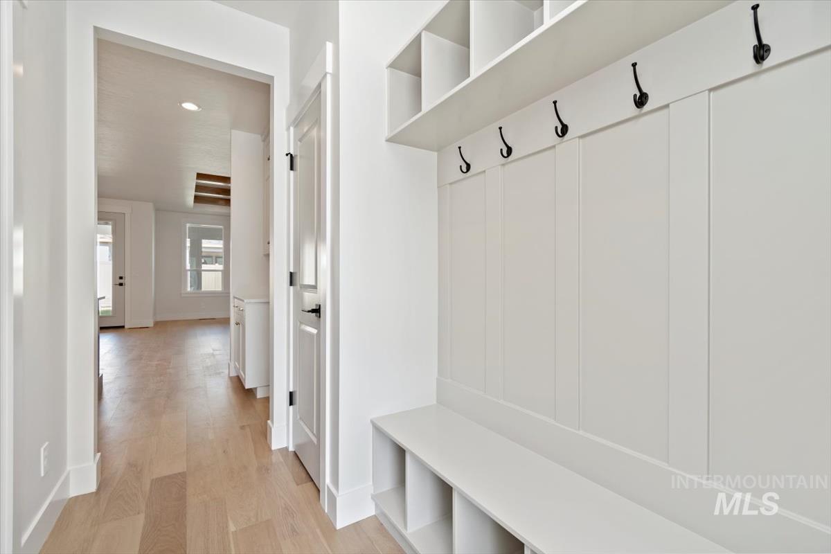 Mudroom featuring light wood-style flooring and recessed lighting