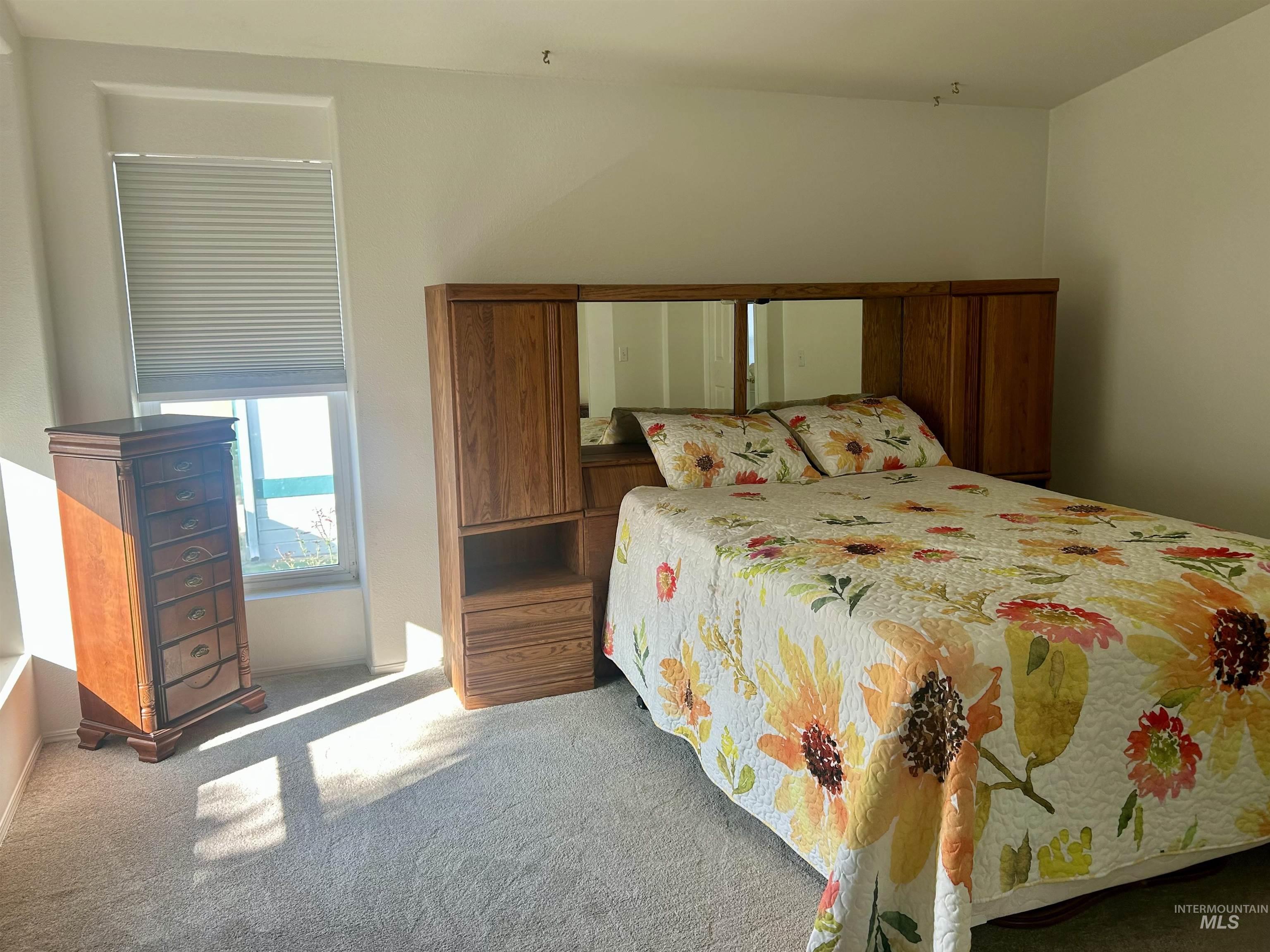 Bedroom with carpet flooring and baseboards