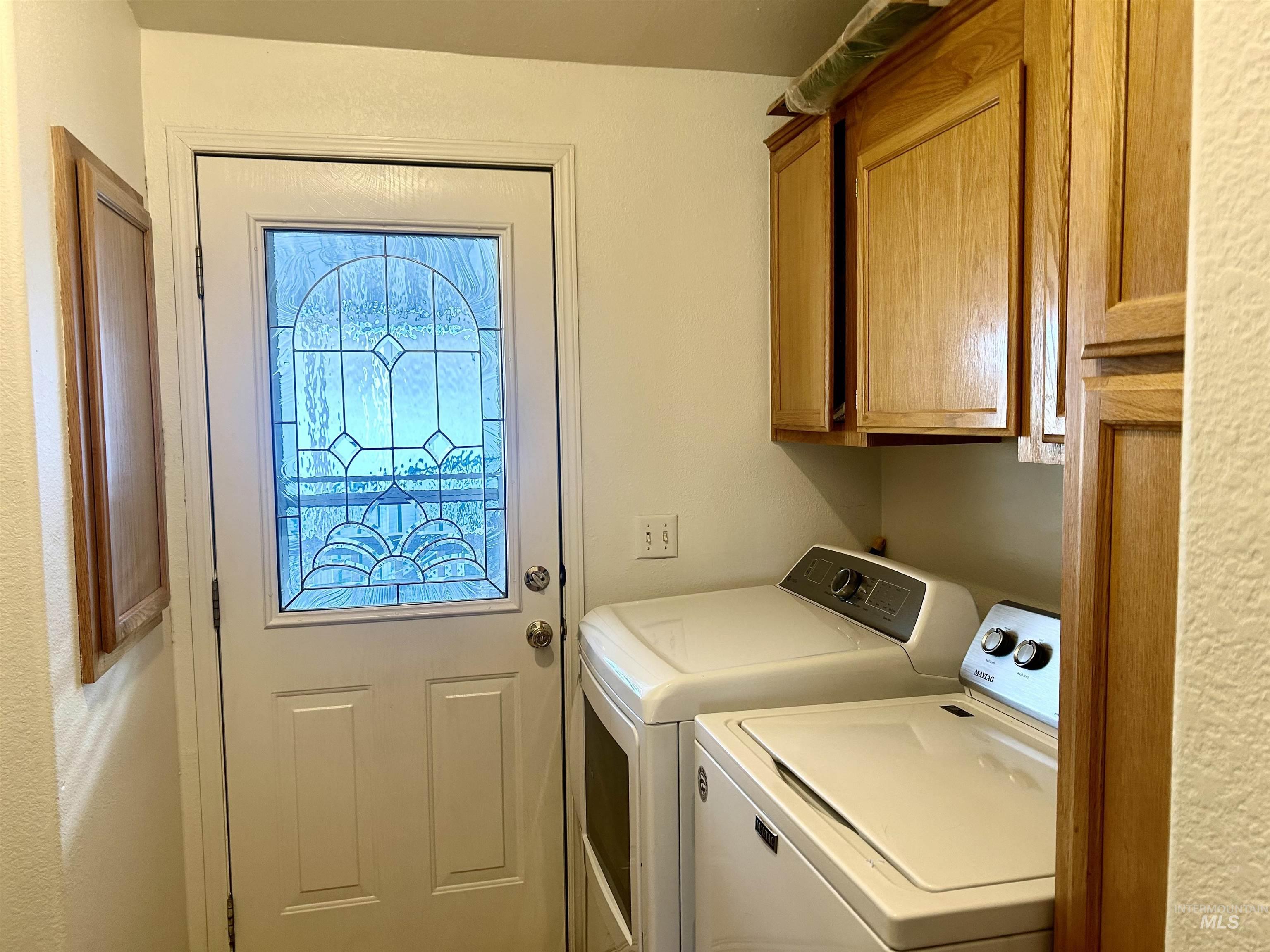 Washroom with cabinet space and separate washer and dryer