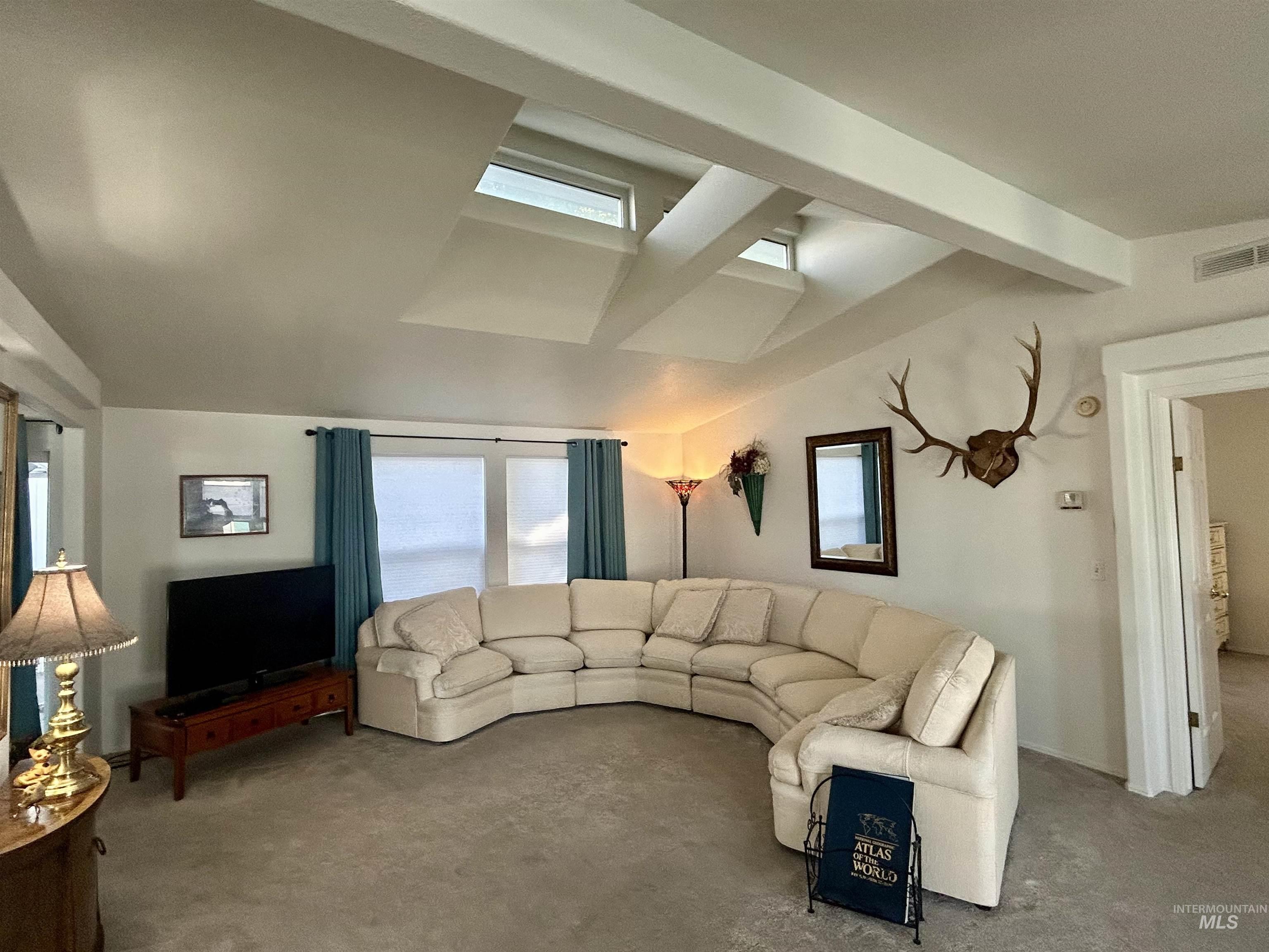 Living area featuring plenty of natural light and carpet flooring