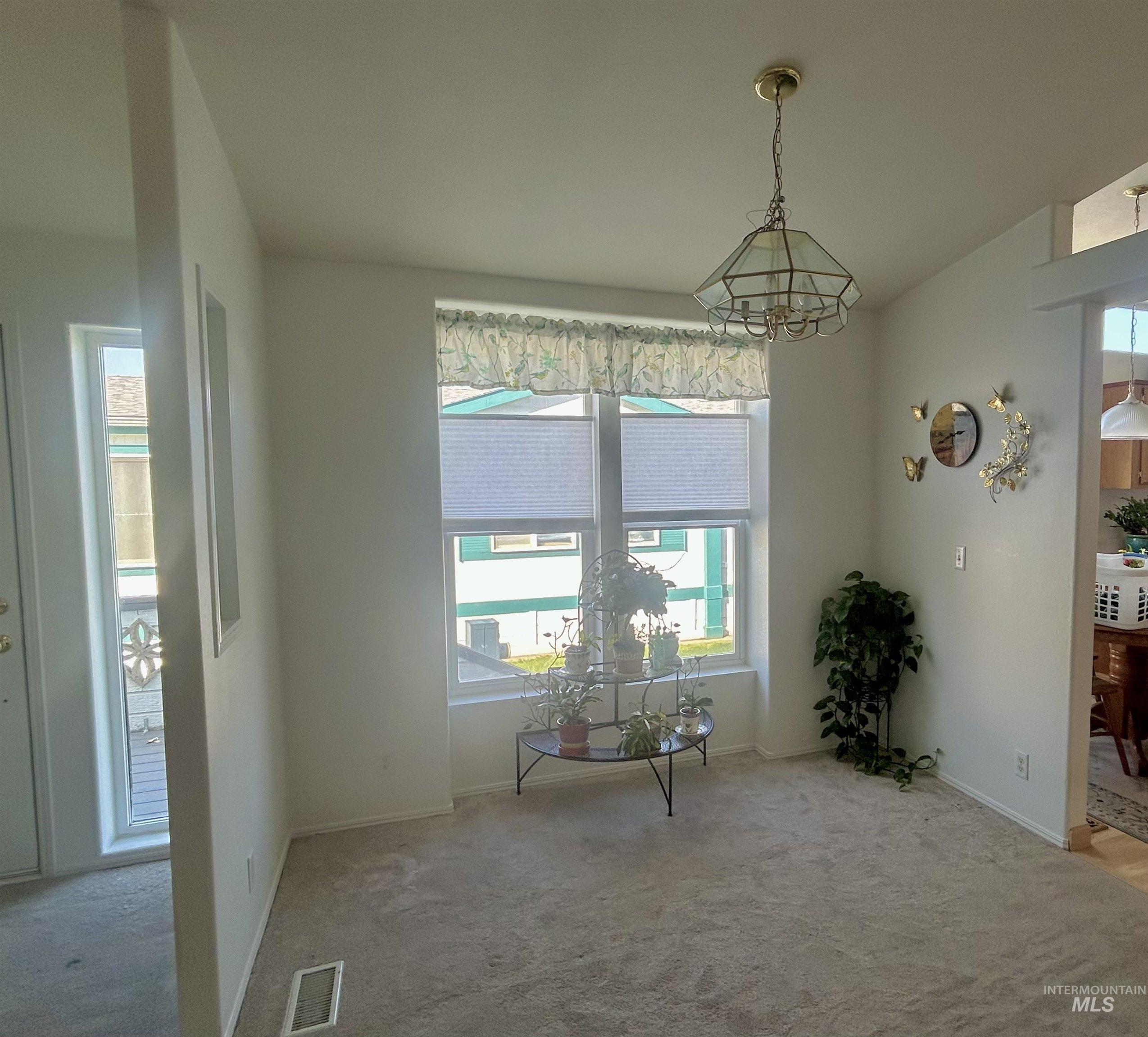Dining area with carpet floors and baseboards