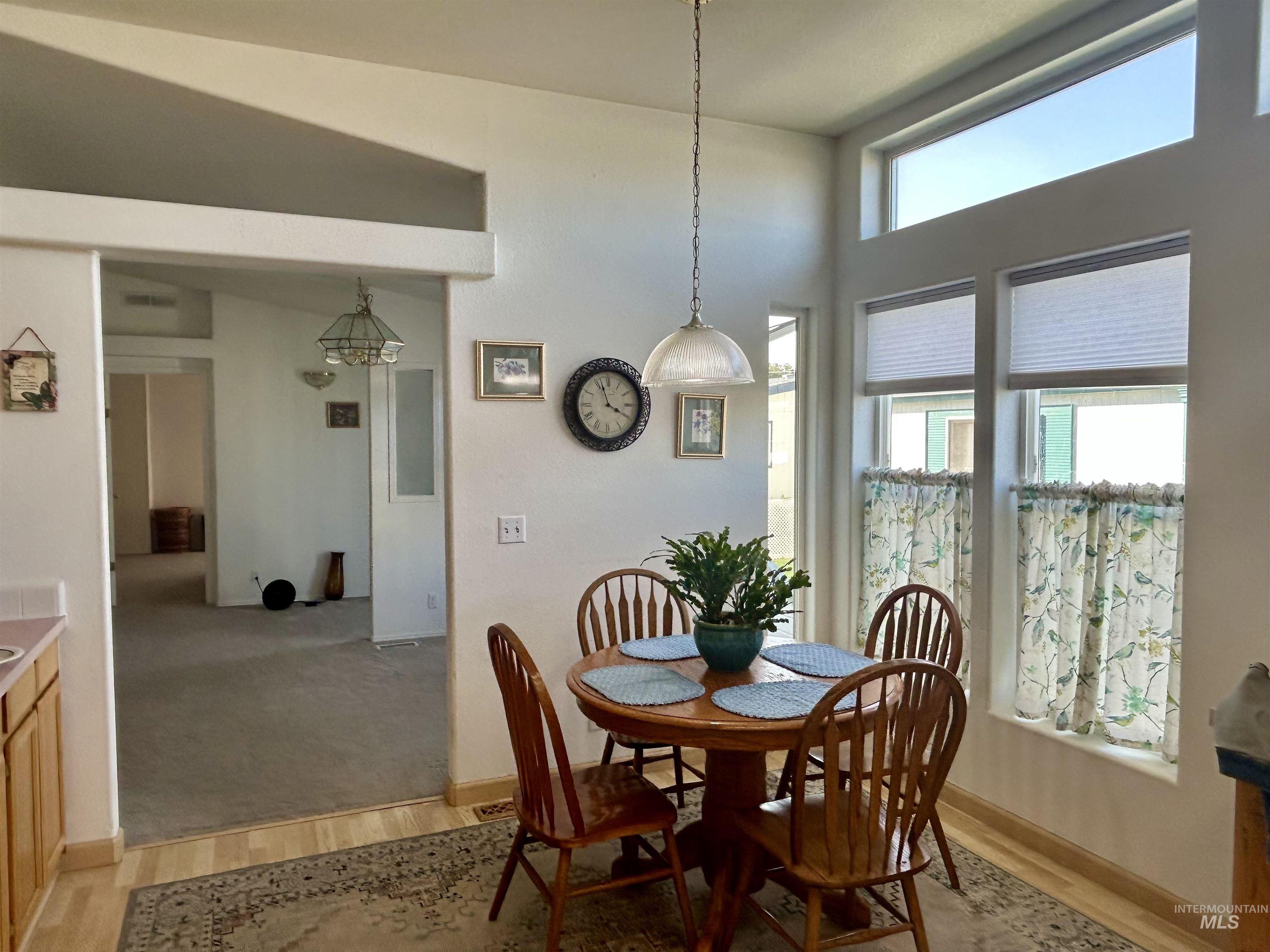 Dining room featuring light wood finished floors and baseboards