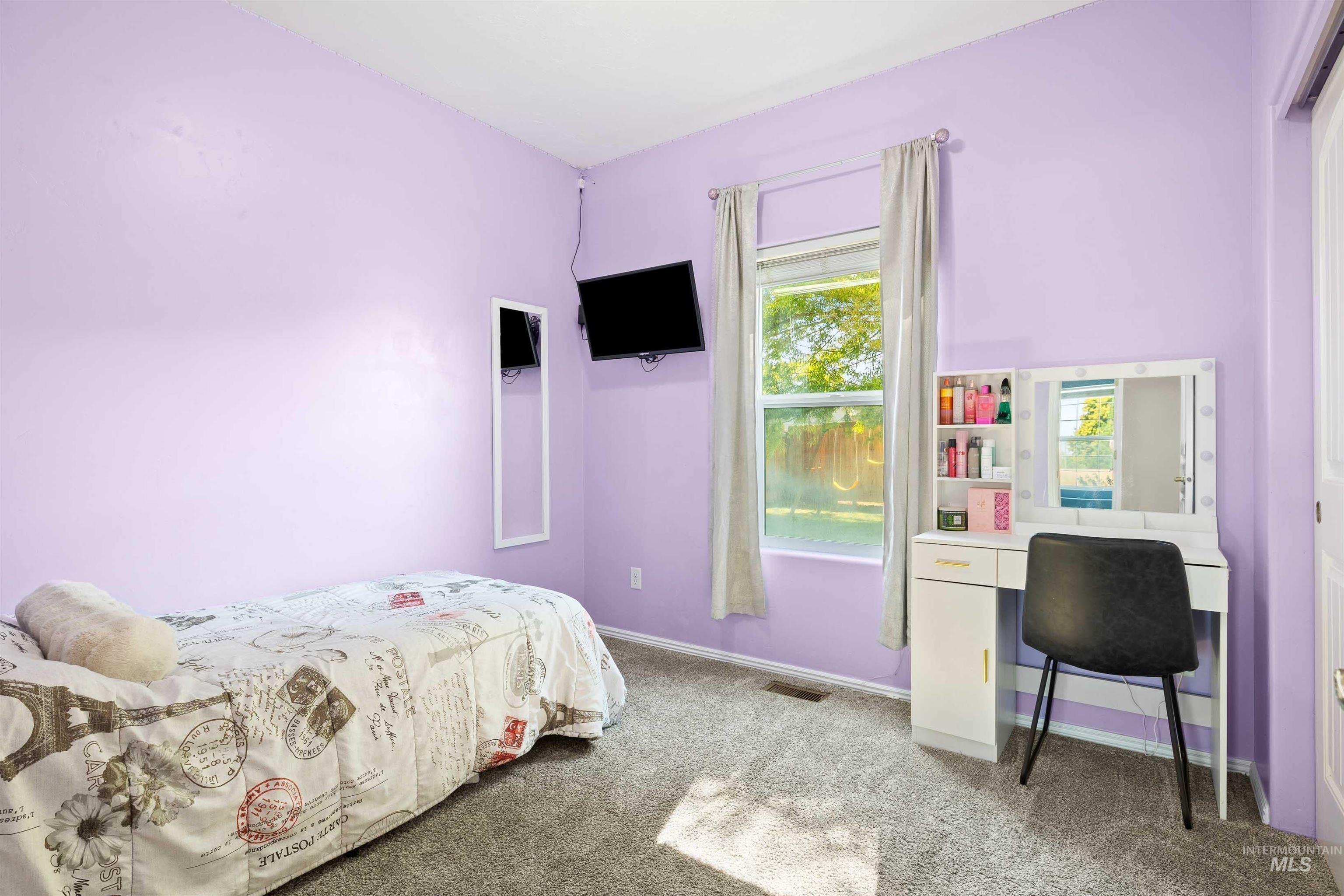 Bedroom featuring light colored carpet and baseboards