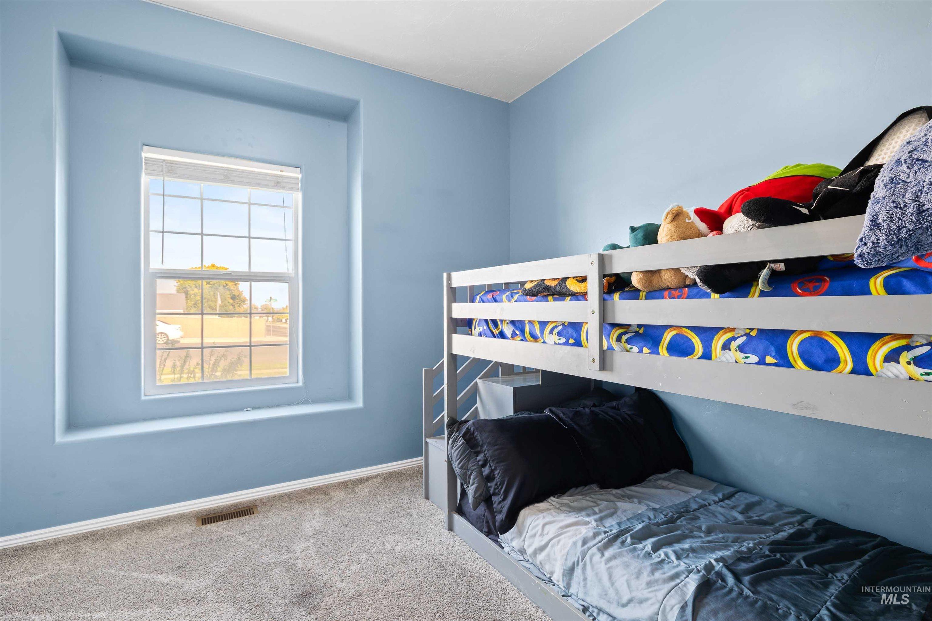 Bedroom with baseboards and carpet floors