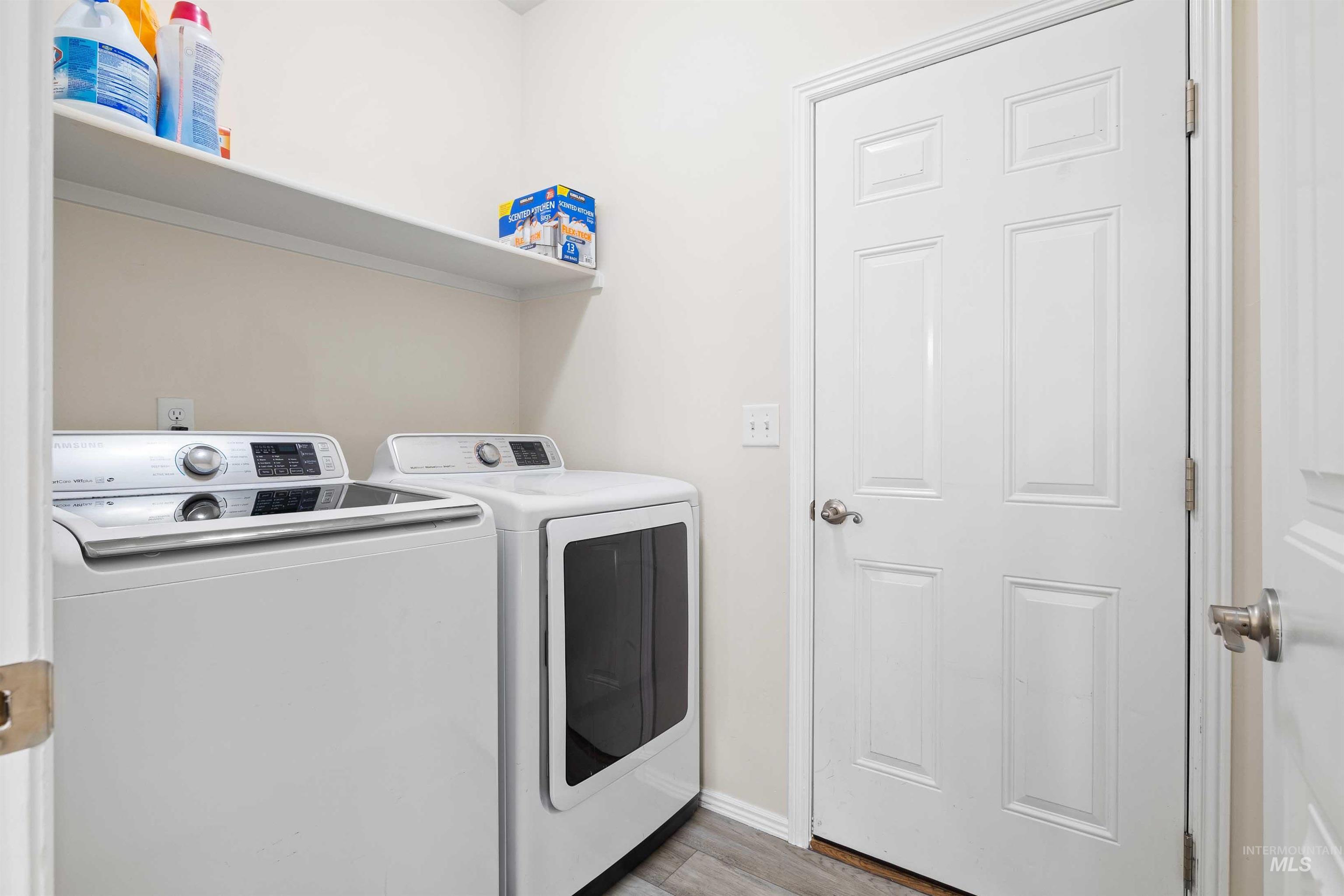 Washroom featuring washer and dryer and light wood-style flooring