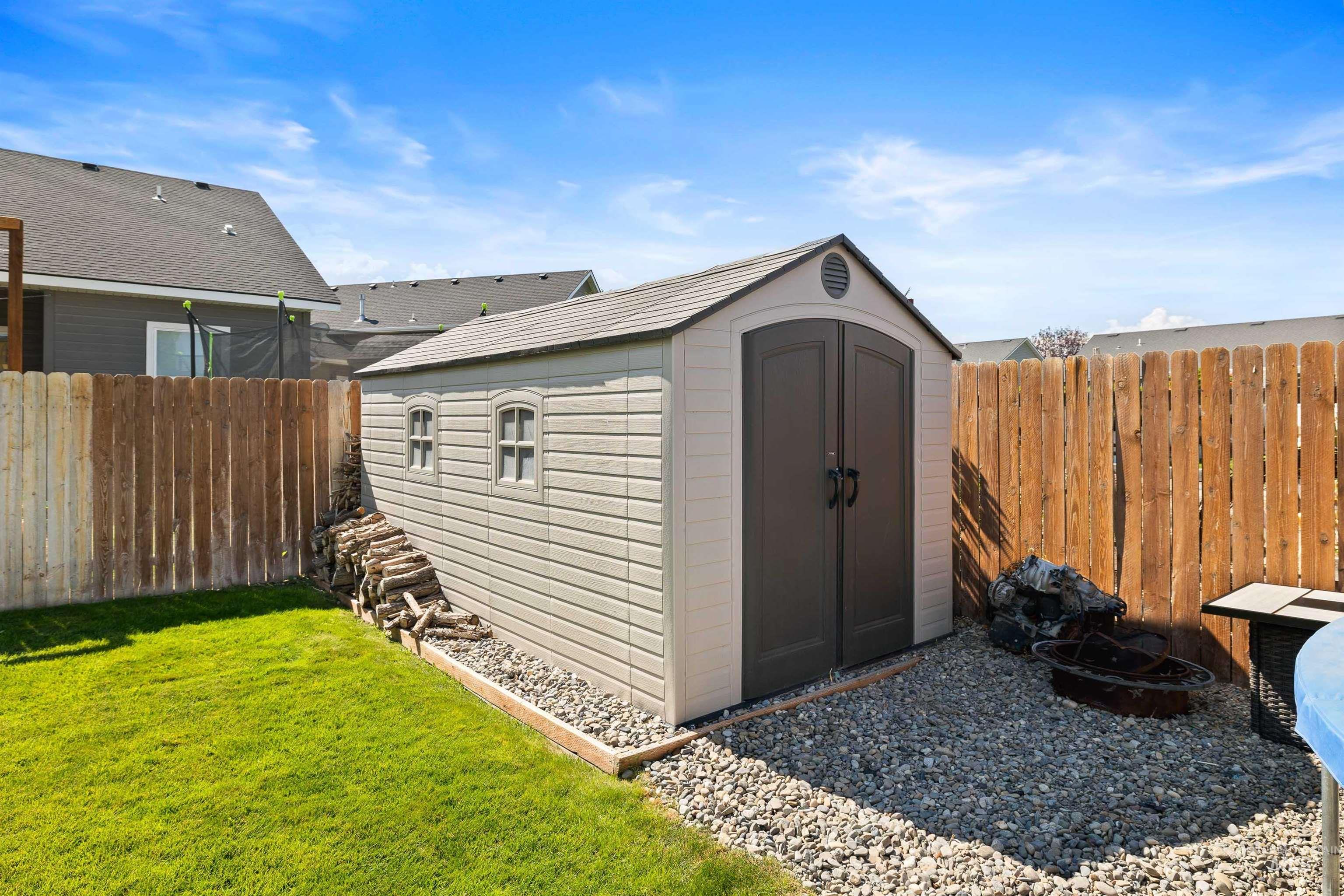 View of shed with a fenced backyard