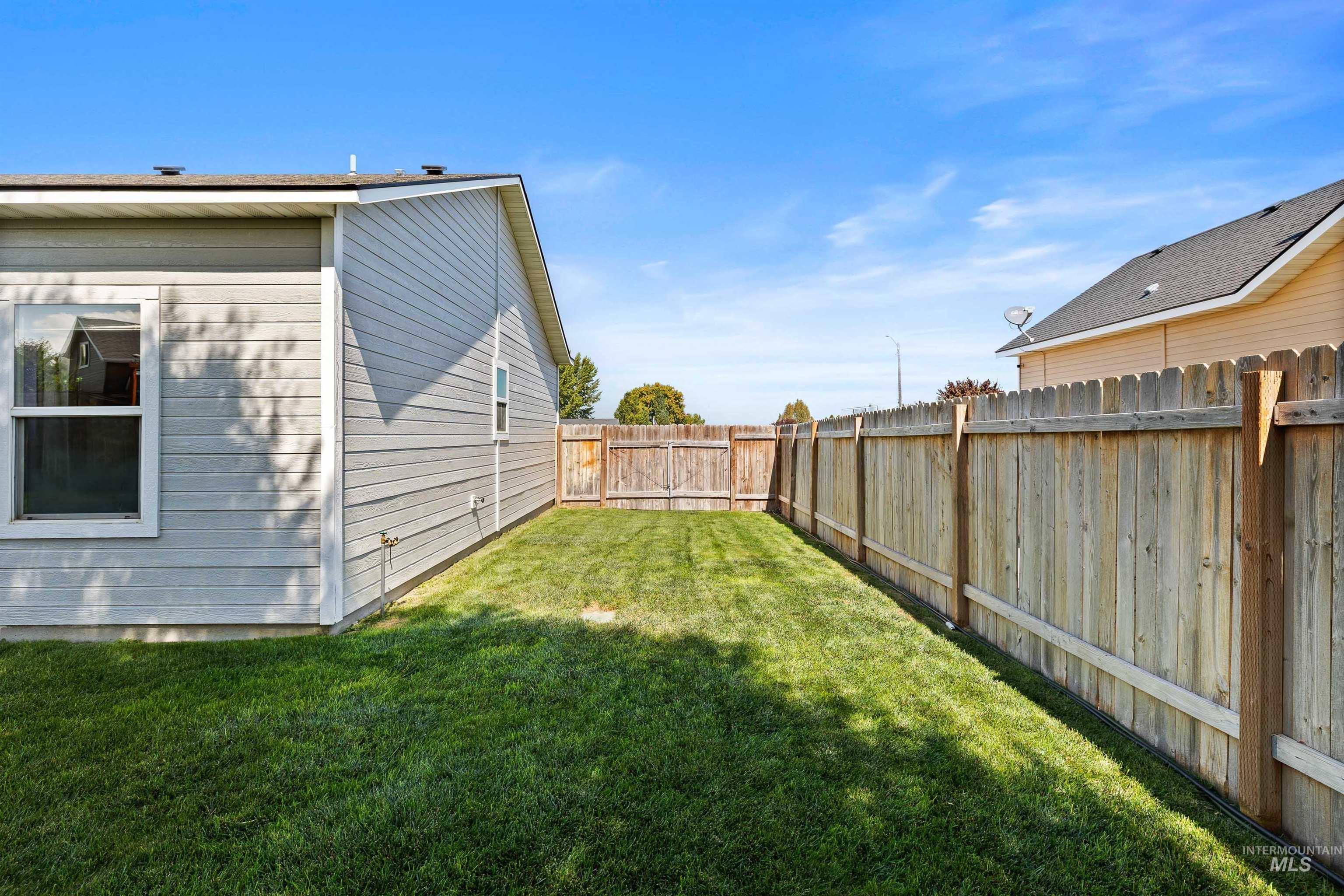 View of fenced backyard