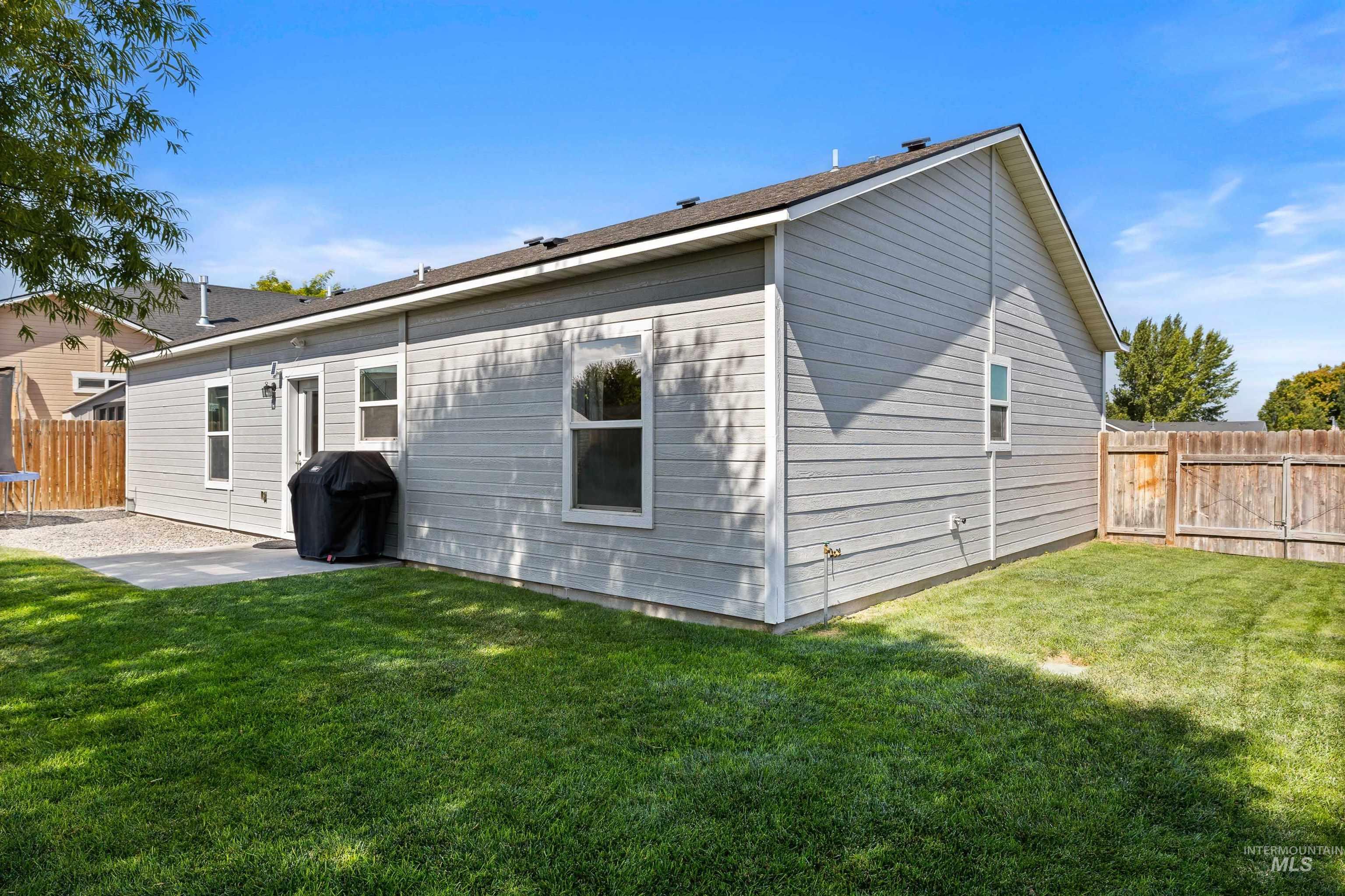 Back of property with a fenced backyard and a patio area