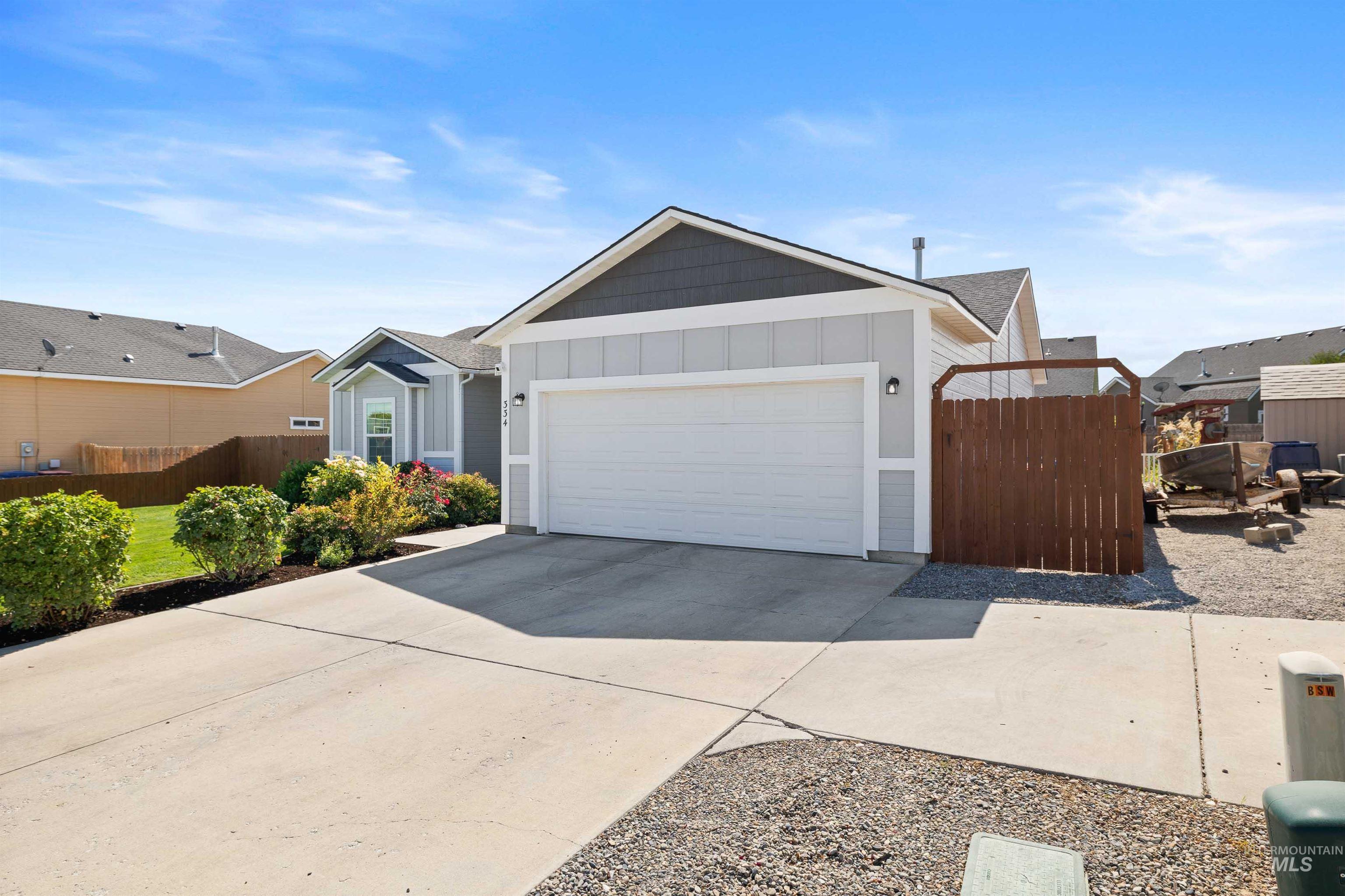 Ranch-style home featuring board and batten siding, concrete driveway, and a garage