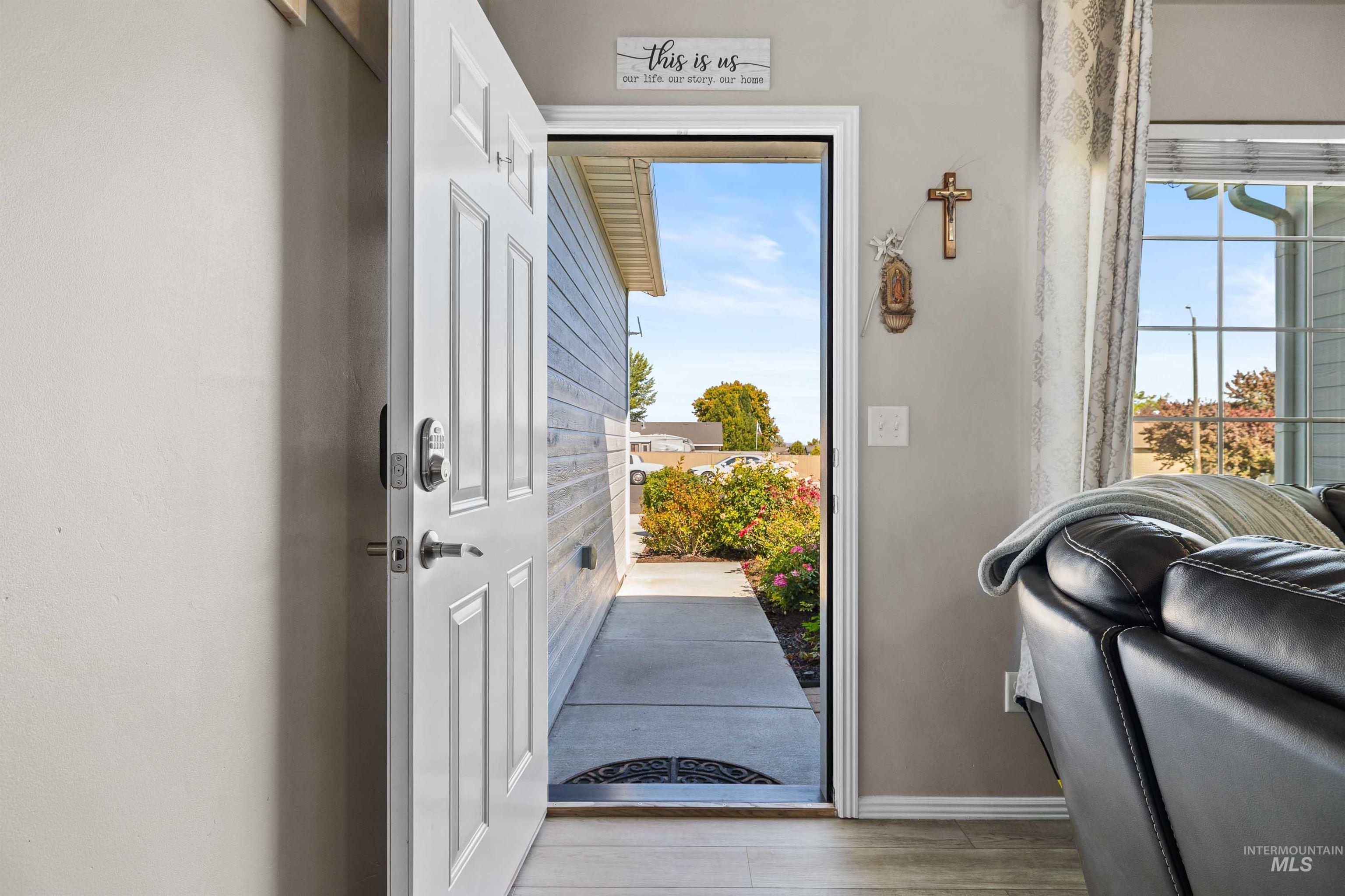 Entryway featuring baseboards and wood finished floors