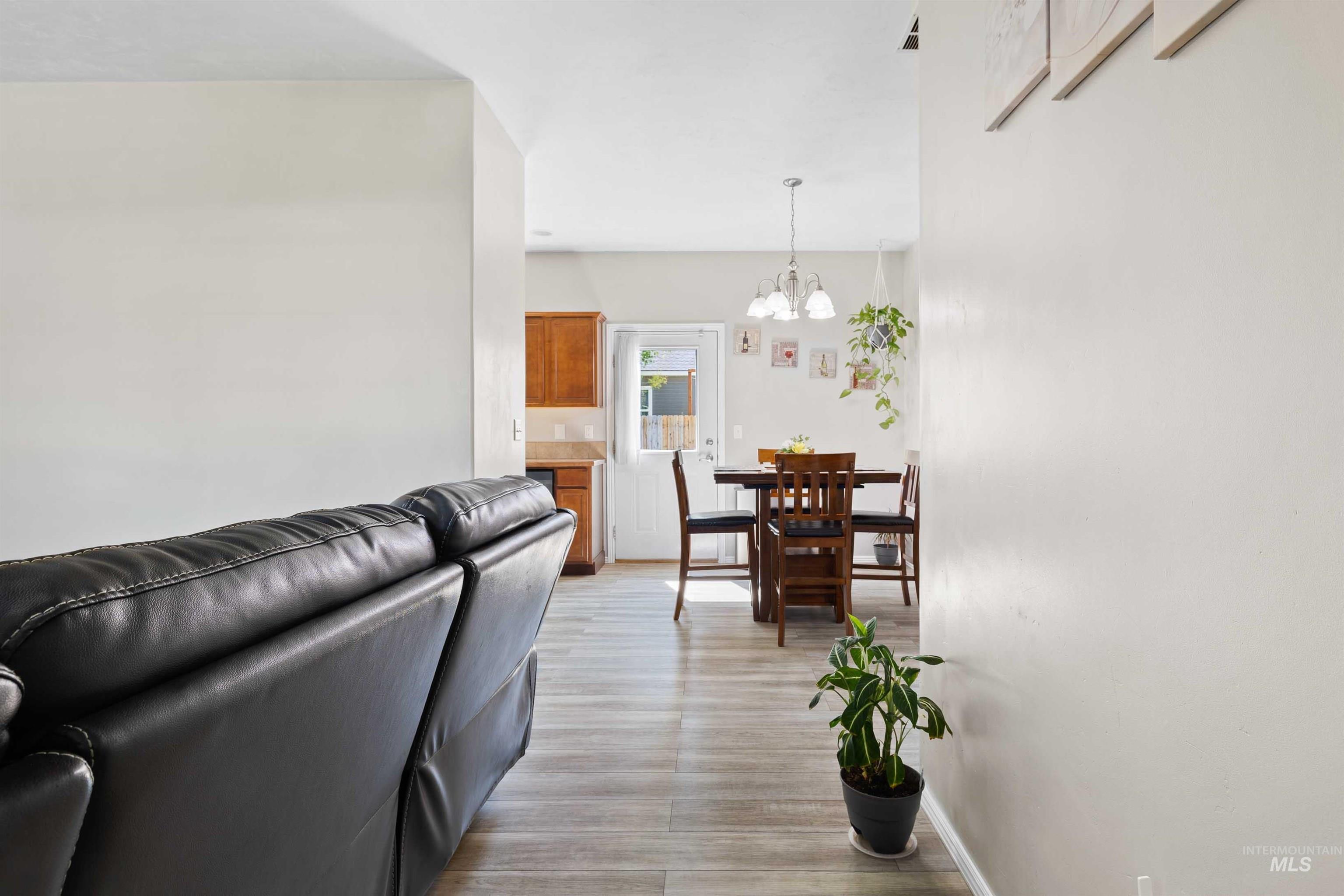 Living room featuring a chandelier and baseboards