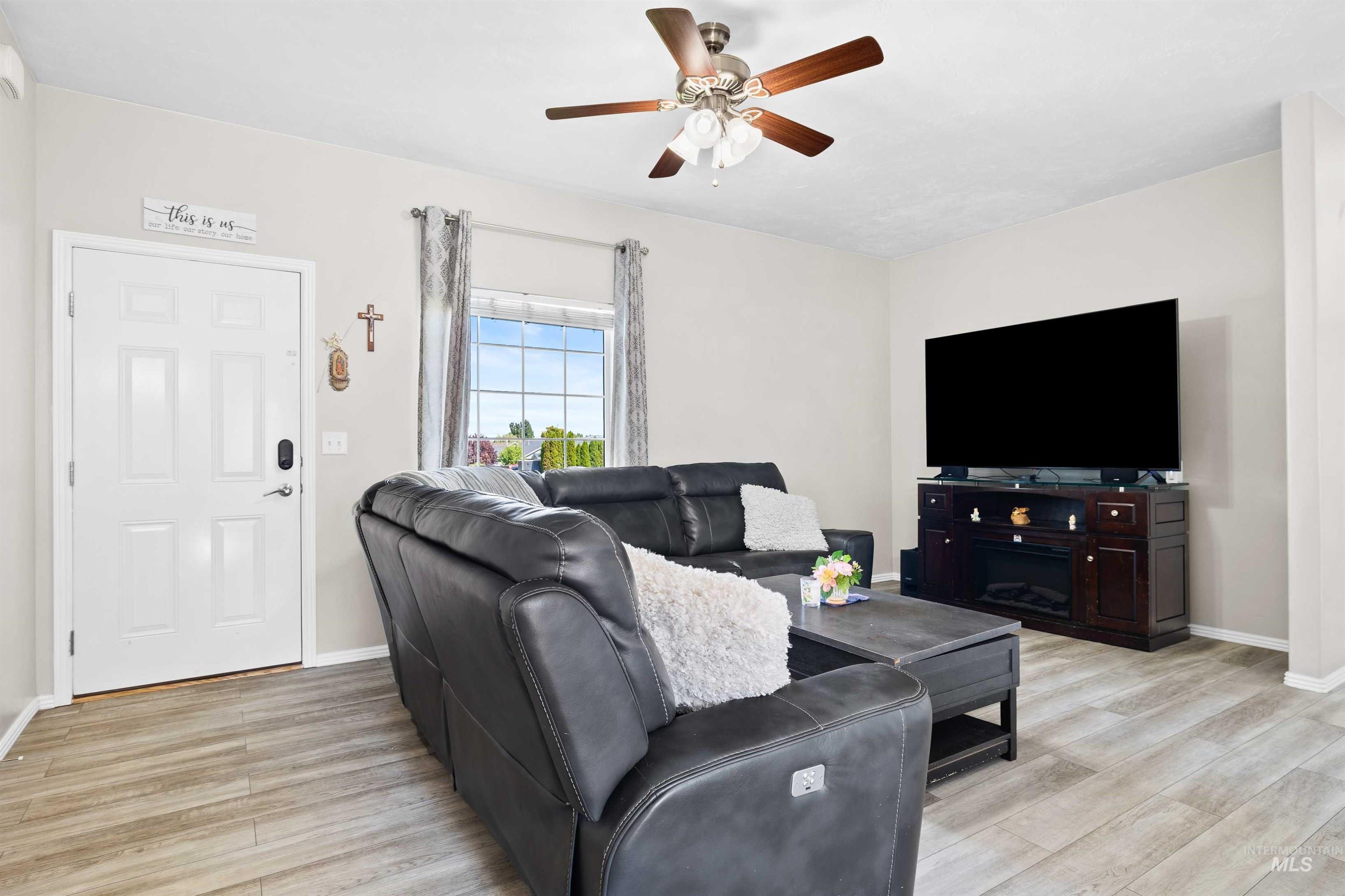 Living room featuring light wood-style floors and ceiling fan