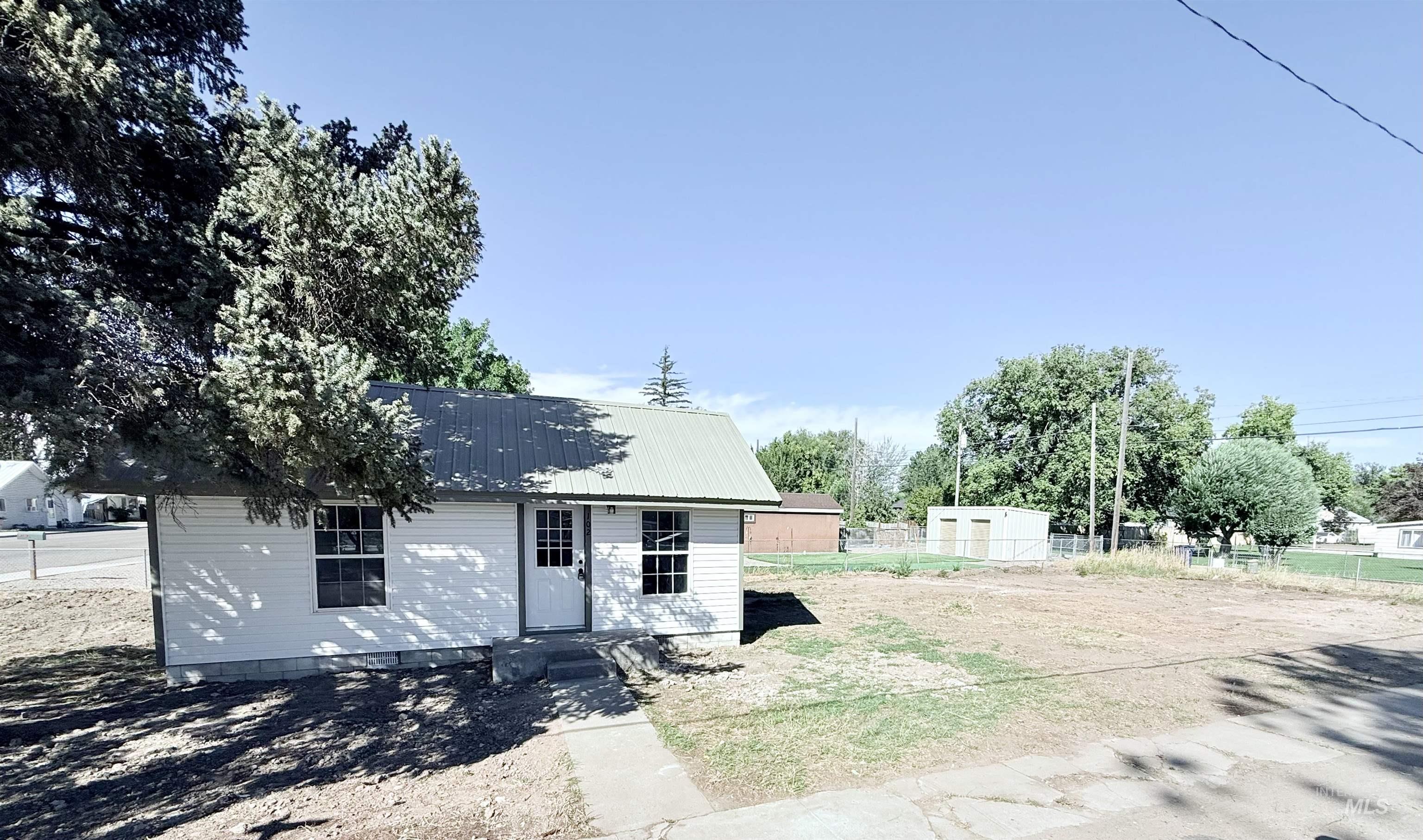 View of front of house with a metal roof