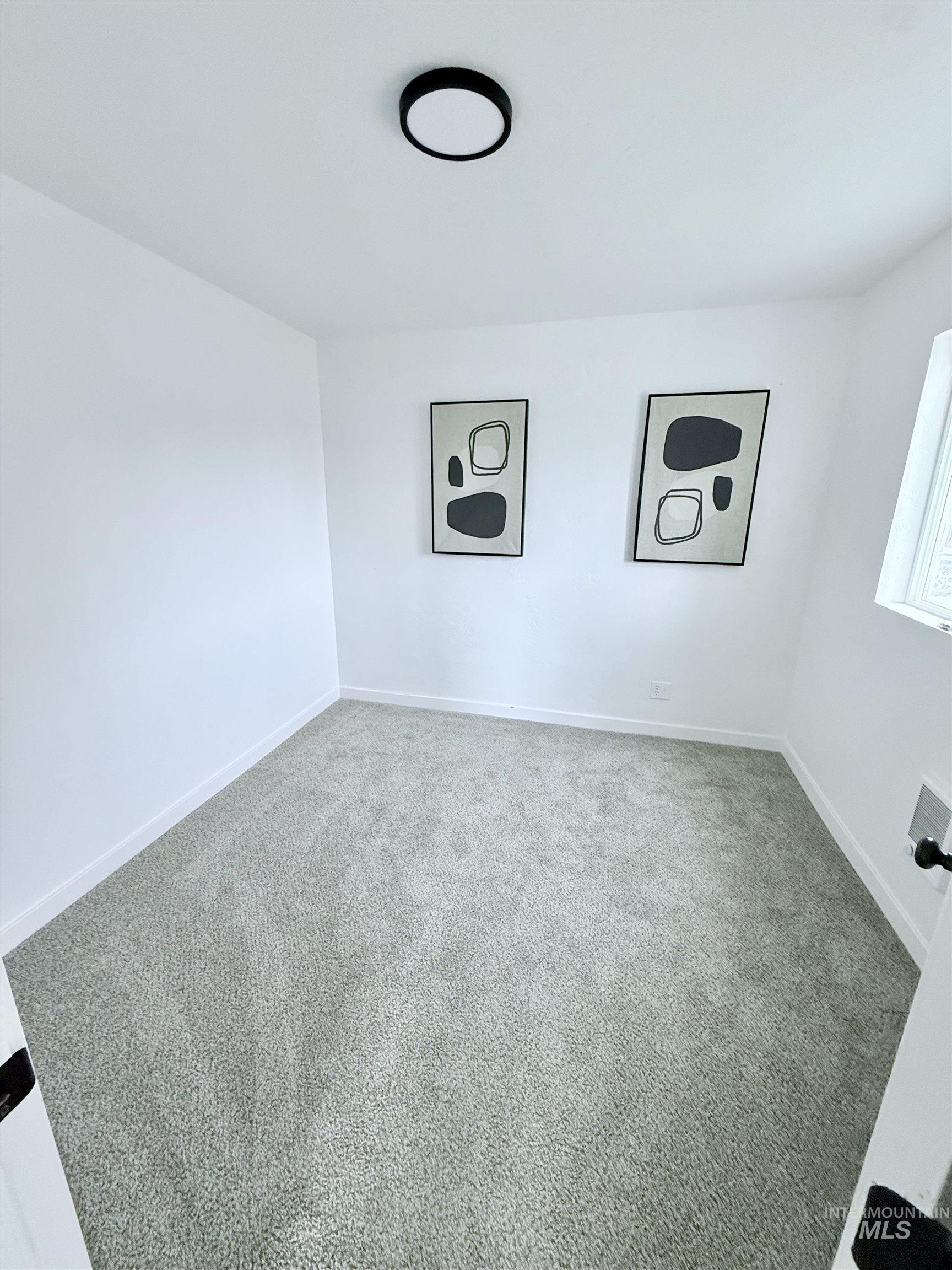 Unfurnished room featuring carpet flooring and baseboards
