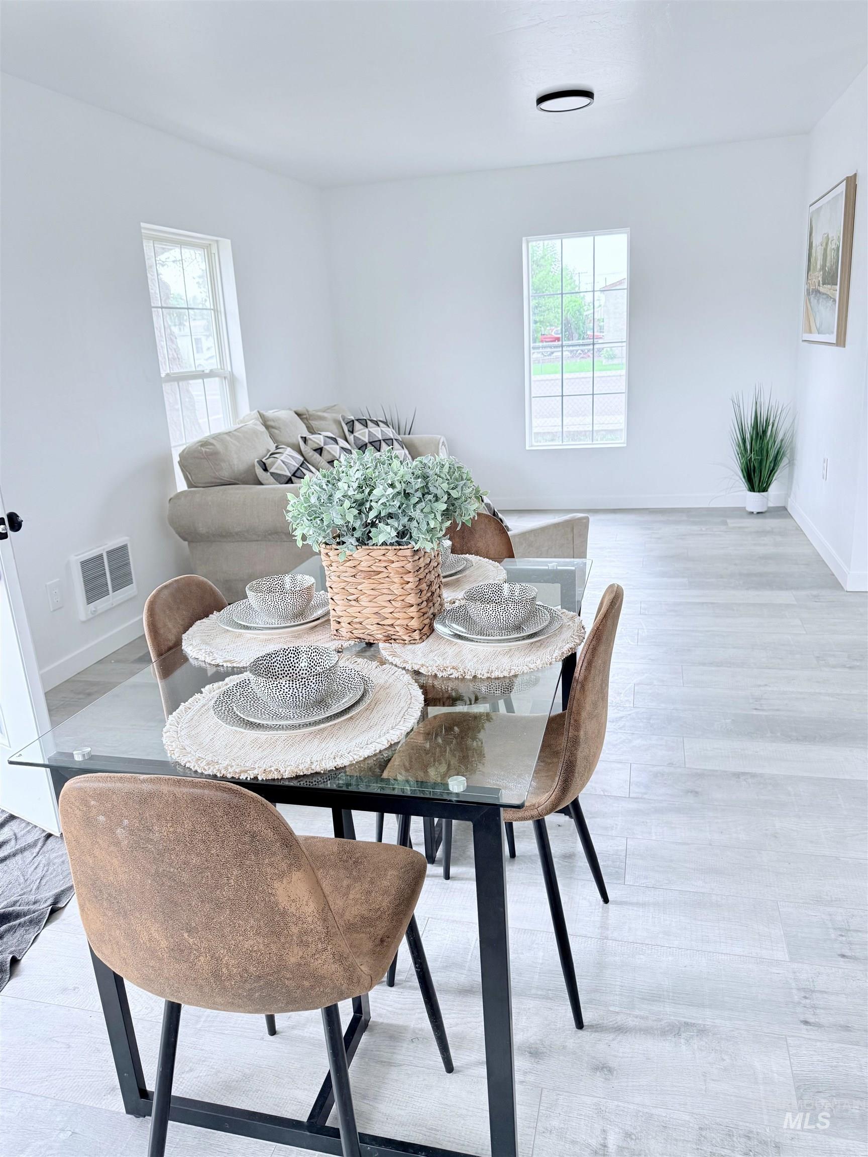 Dining room featuring light wood finished floors and baseboards