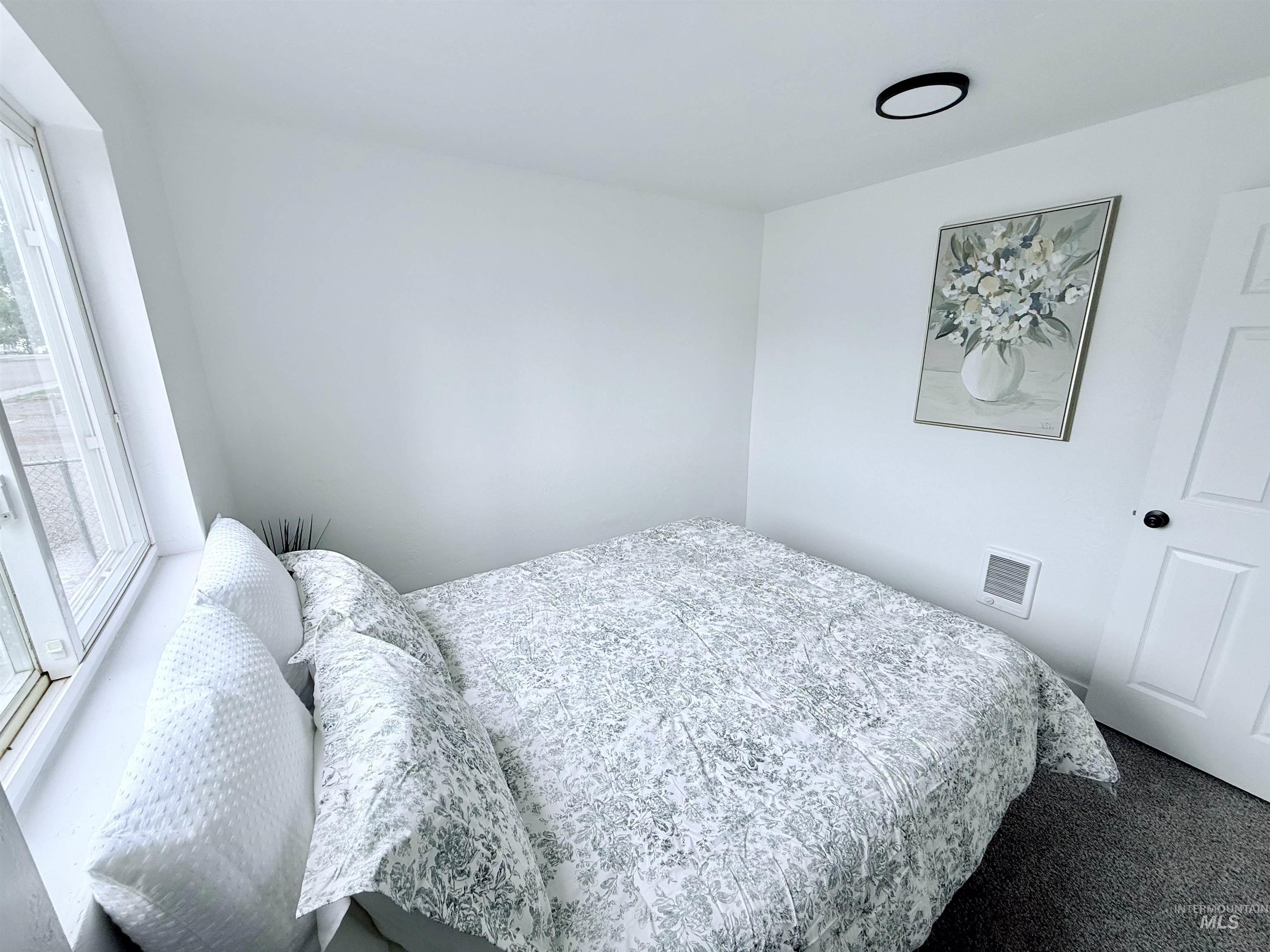 Bedroom with carpet and access to outside