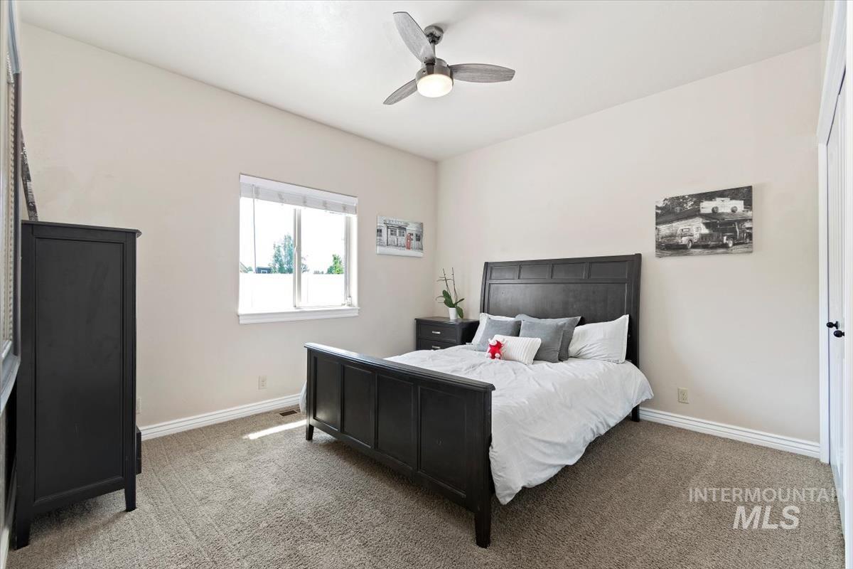 Bedroom featuring carpet flooring and ceiling fan