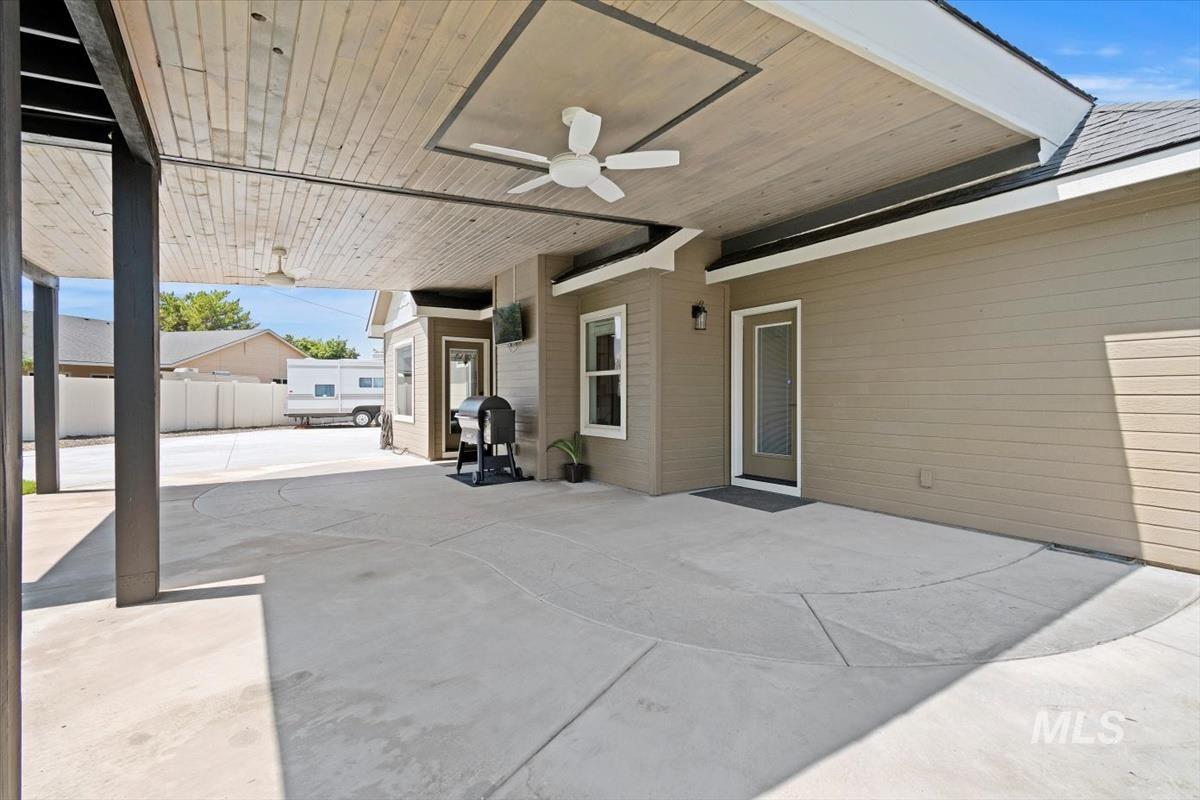 View of patio featuring ceiling fan and area for grilling