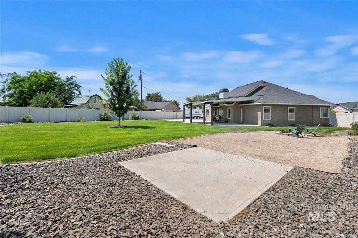 Back of house featuring a patio, a fenced backyard, and a chimney