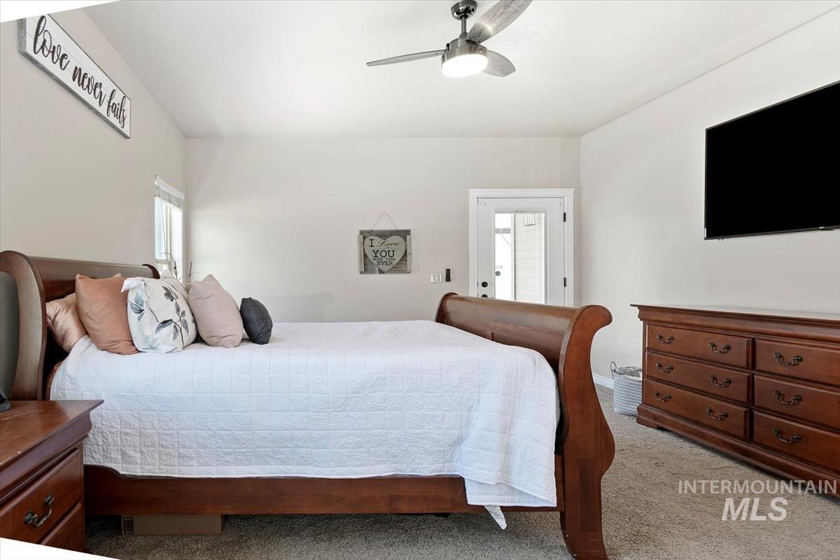 Carpeted bedroom with ceiling fan