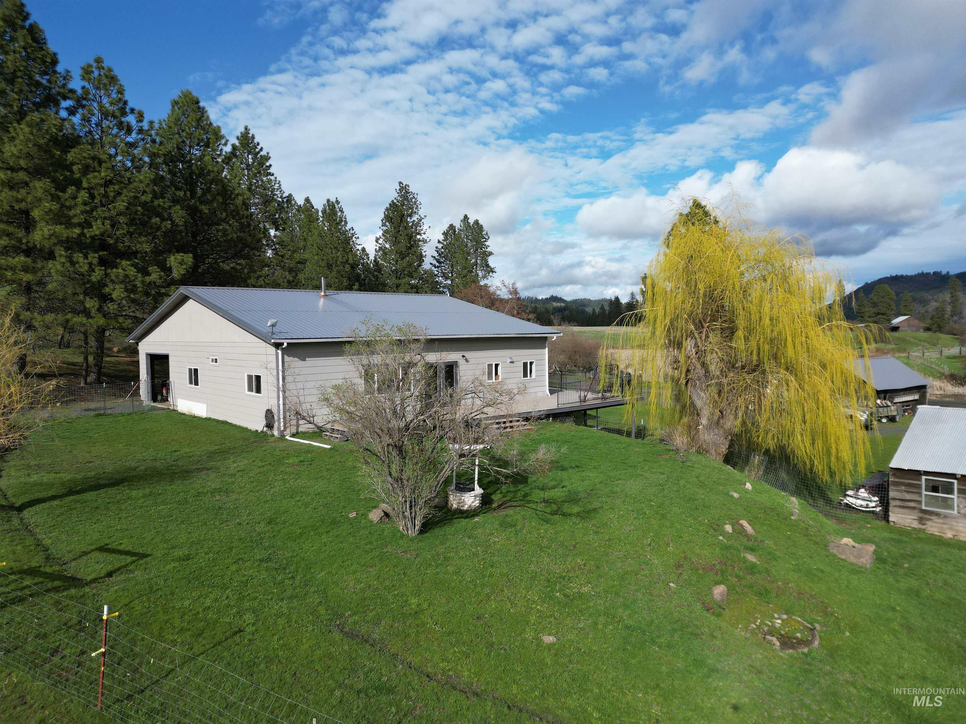 Rear view of property with a lawn