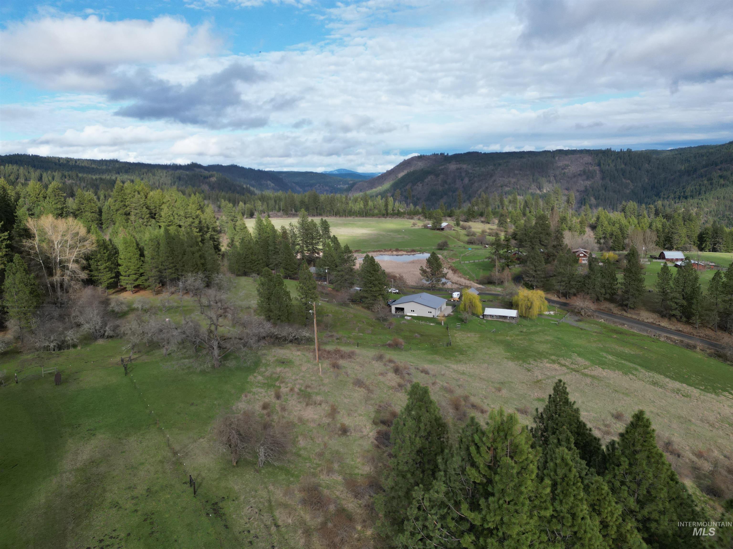 Aerial overview of property's location with rural landscape and a mountain backdrop