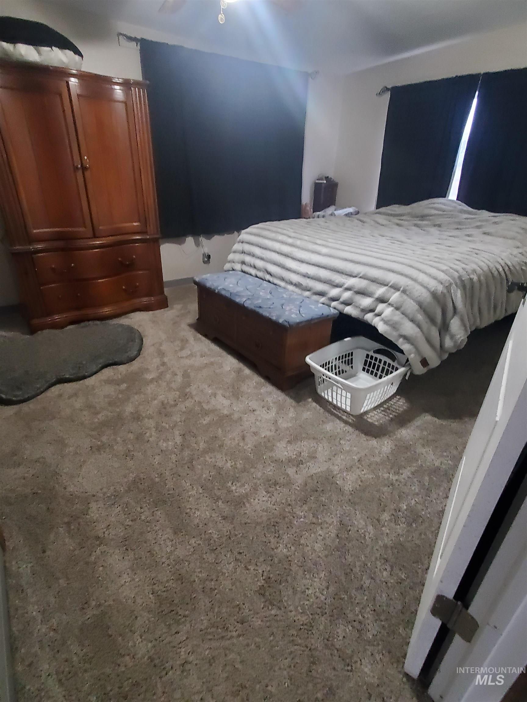 Bedroom with carpet floors and a ceiling fan