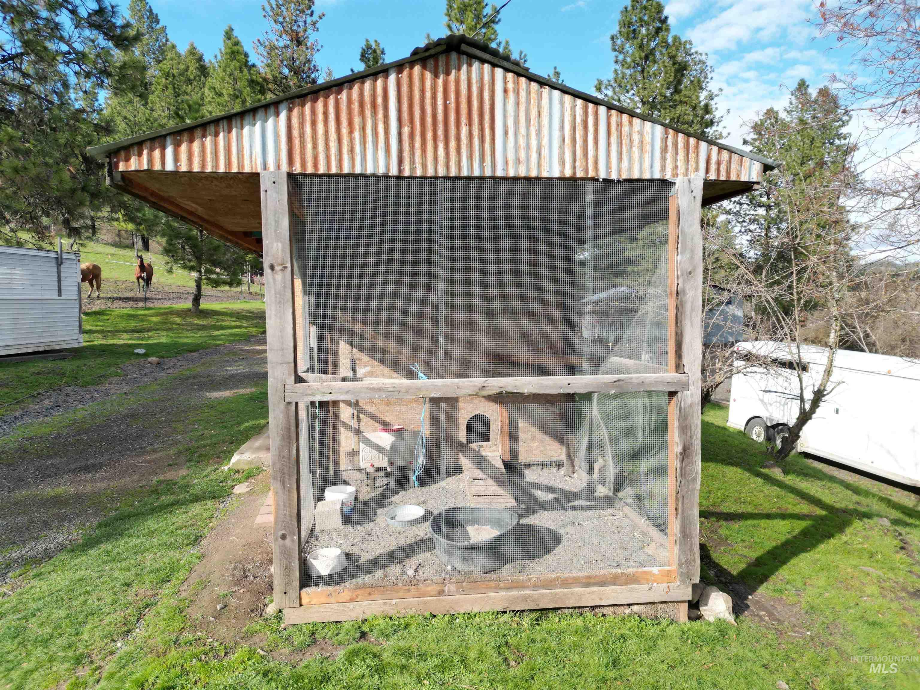 View of poultry coop with a sunroom and a yard