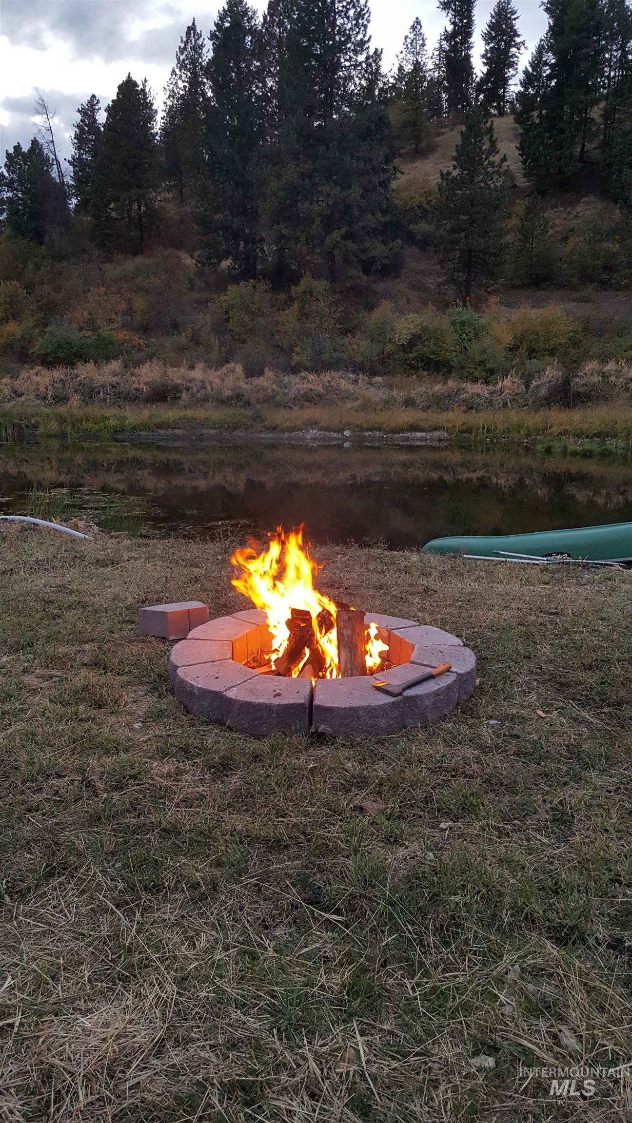 View of yard with an outdoor fire pit